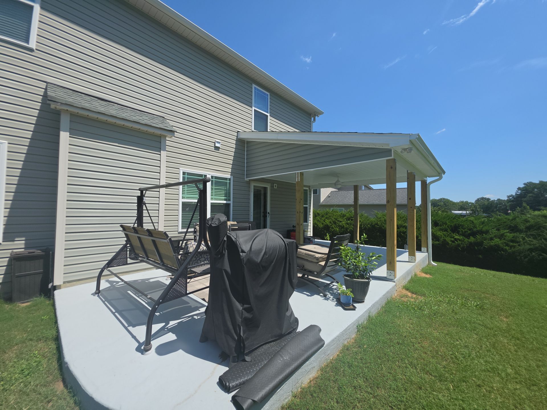 Covered Patio Roof Construction with Architectural Shingles in Garner by The Remodeling Company