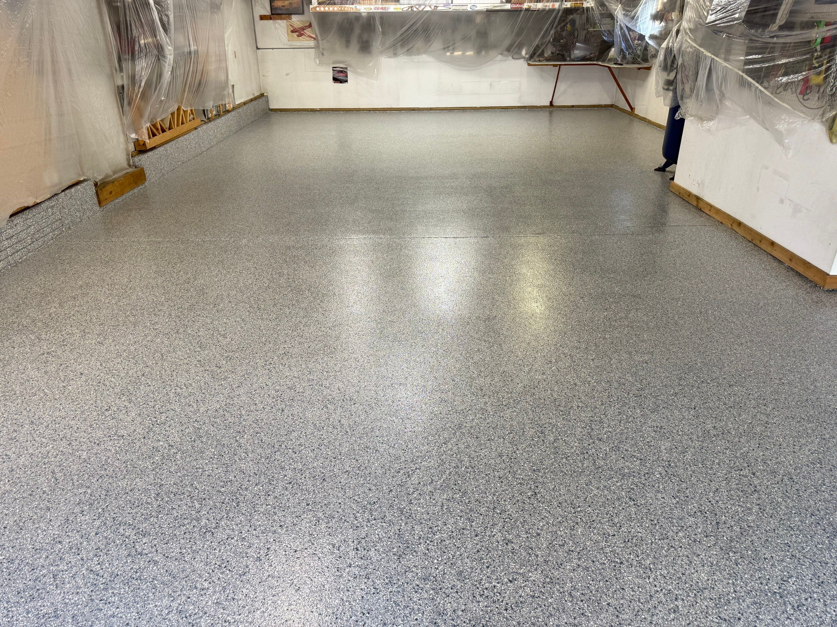 High-Performance Polyurea Garage Floor Coating and Stem Wall Finishing in Sioux Falls by Select Painting, Coatings & Garage Cabinets