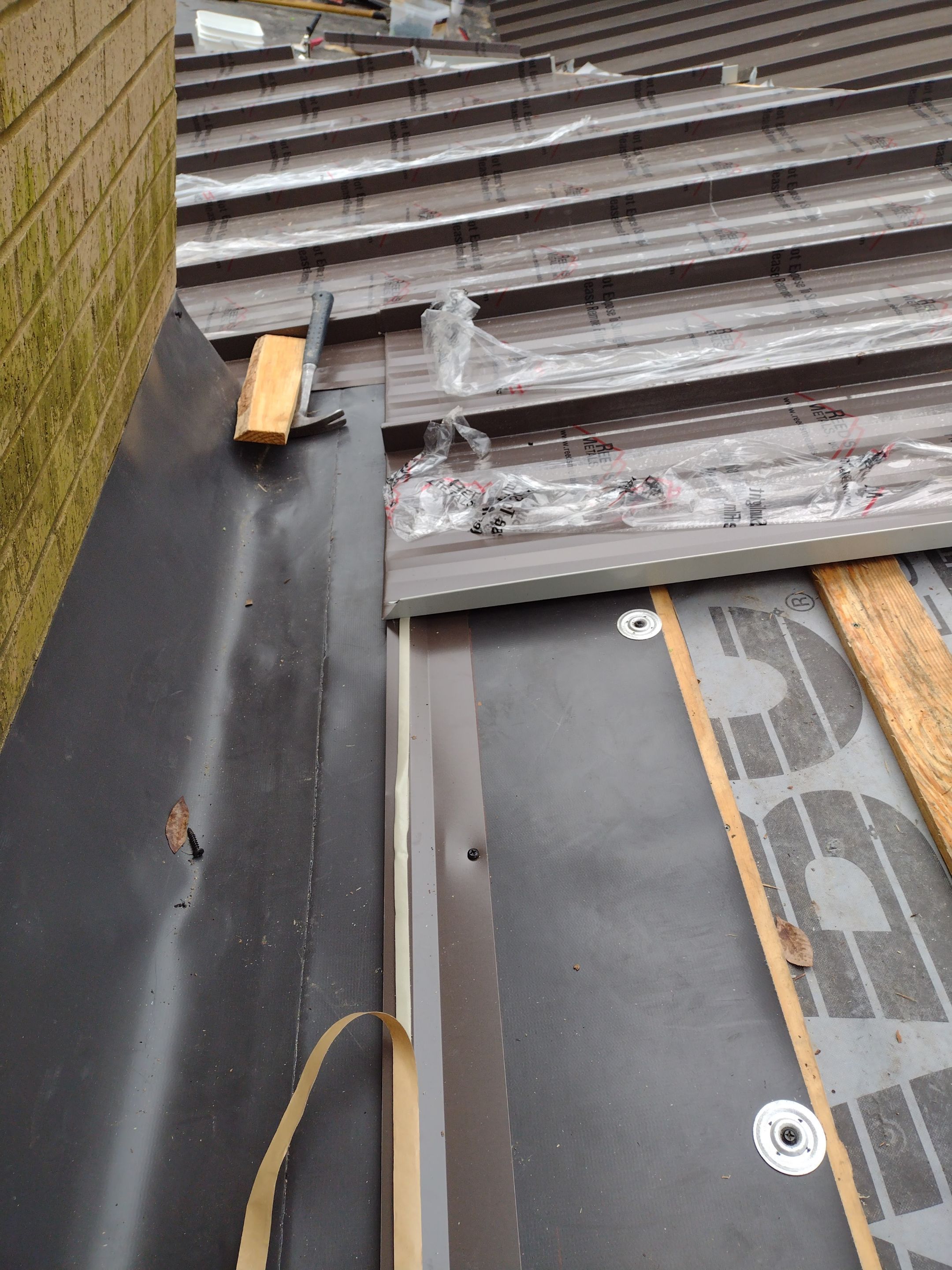 Residential Roofing Installation using PVC membrane and 24 gauge Standing Seam Metal by Hostetler Roofing