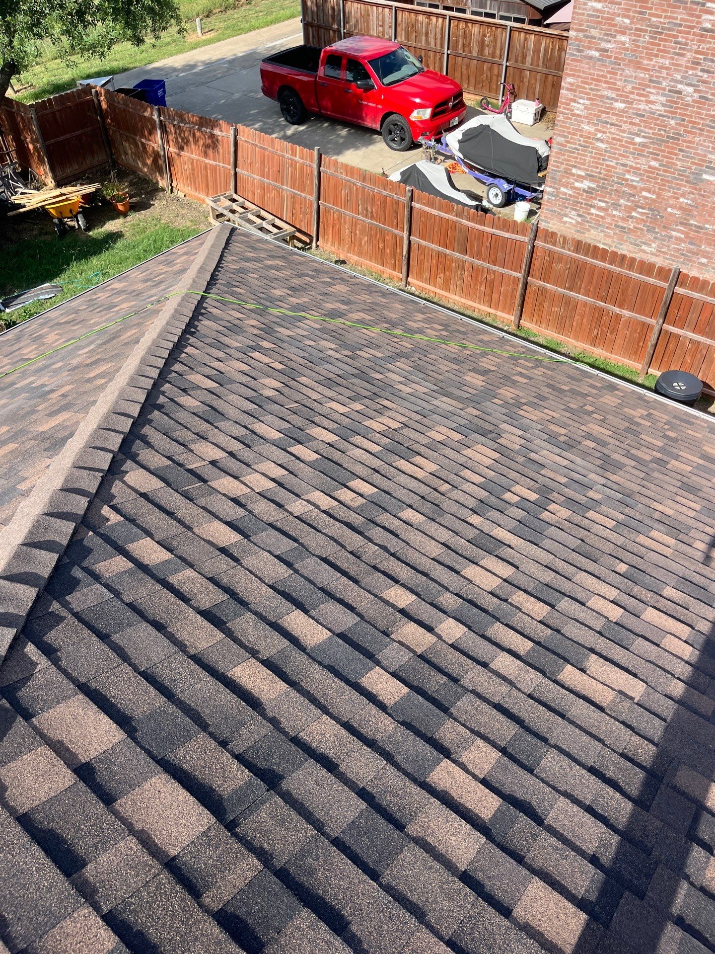 IKO Shadow Brown-Medium brown brick house by Tejas Roofworks + Restoration