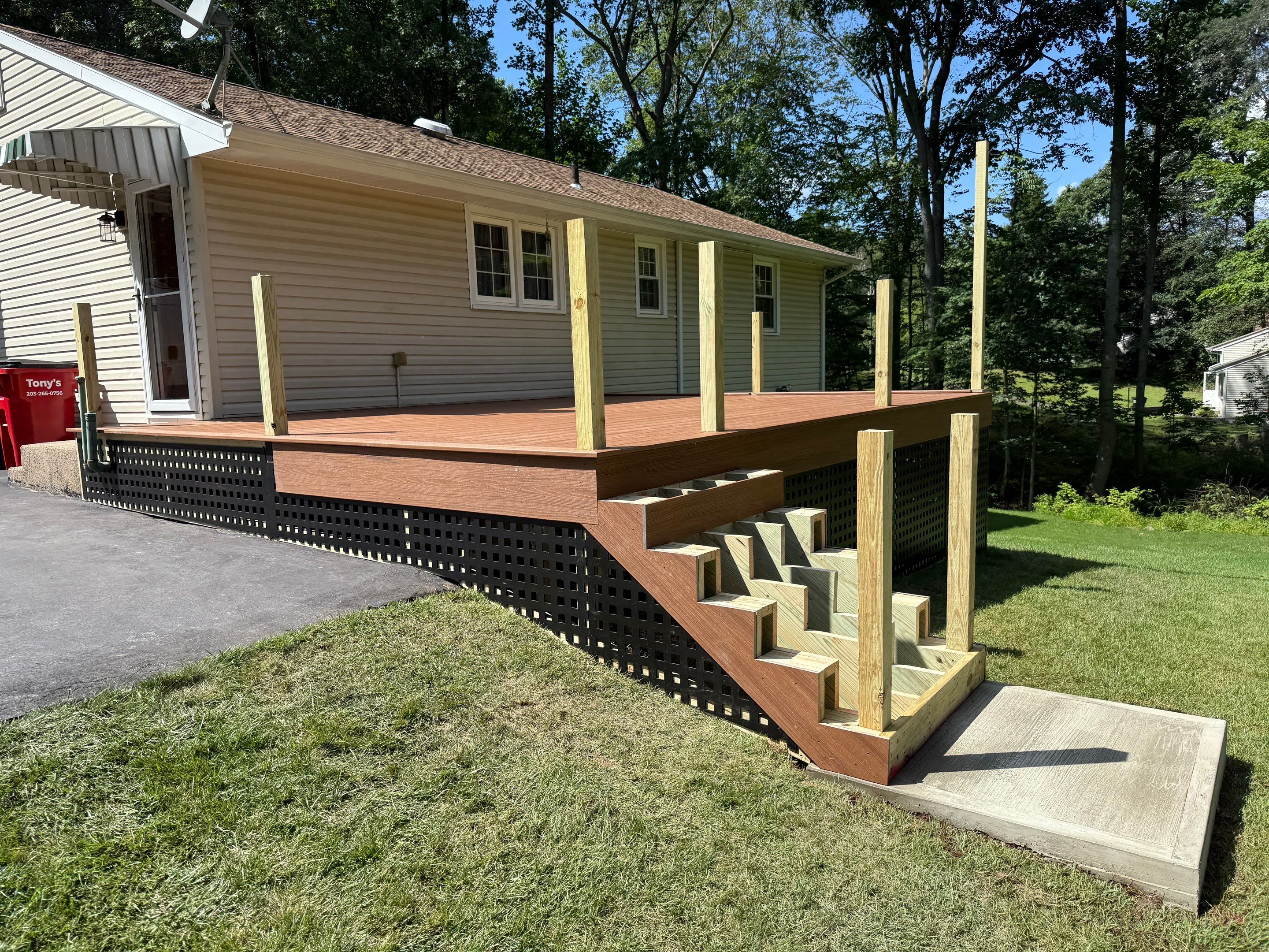 Replacement Deck, Trex Tropical Tiki torch , Matching Fascia. Black Transcend railing and Lattice. by DiGiorgi Roofing and Siding Inc