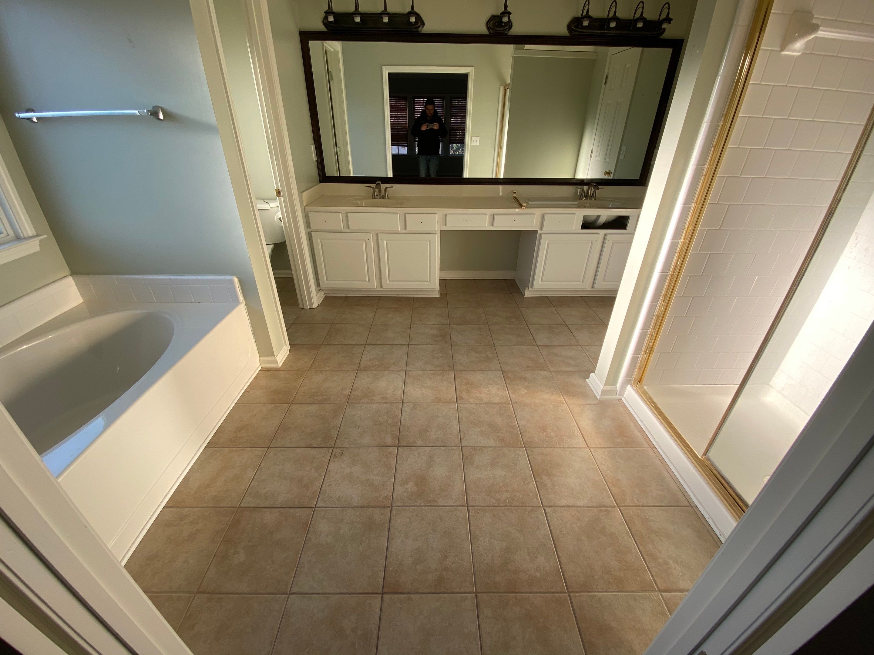 Master Bathroom Renovation Featuring Marble-Look Tile and Frameless Glass by Swift Home Renovations