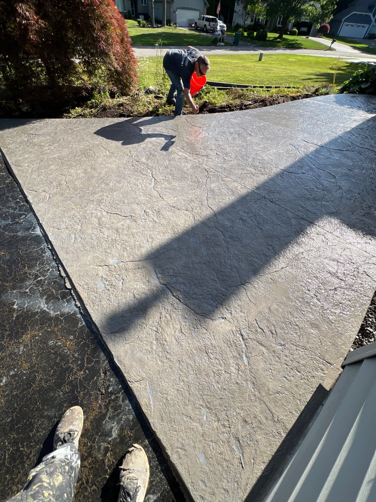 Heavy stone textured stamped concrete patio  by NG Masonry & Construction LLC