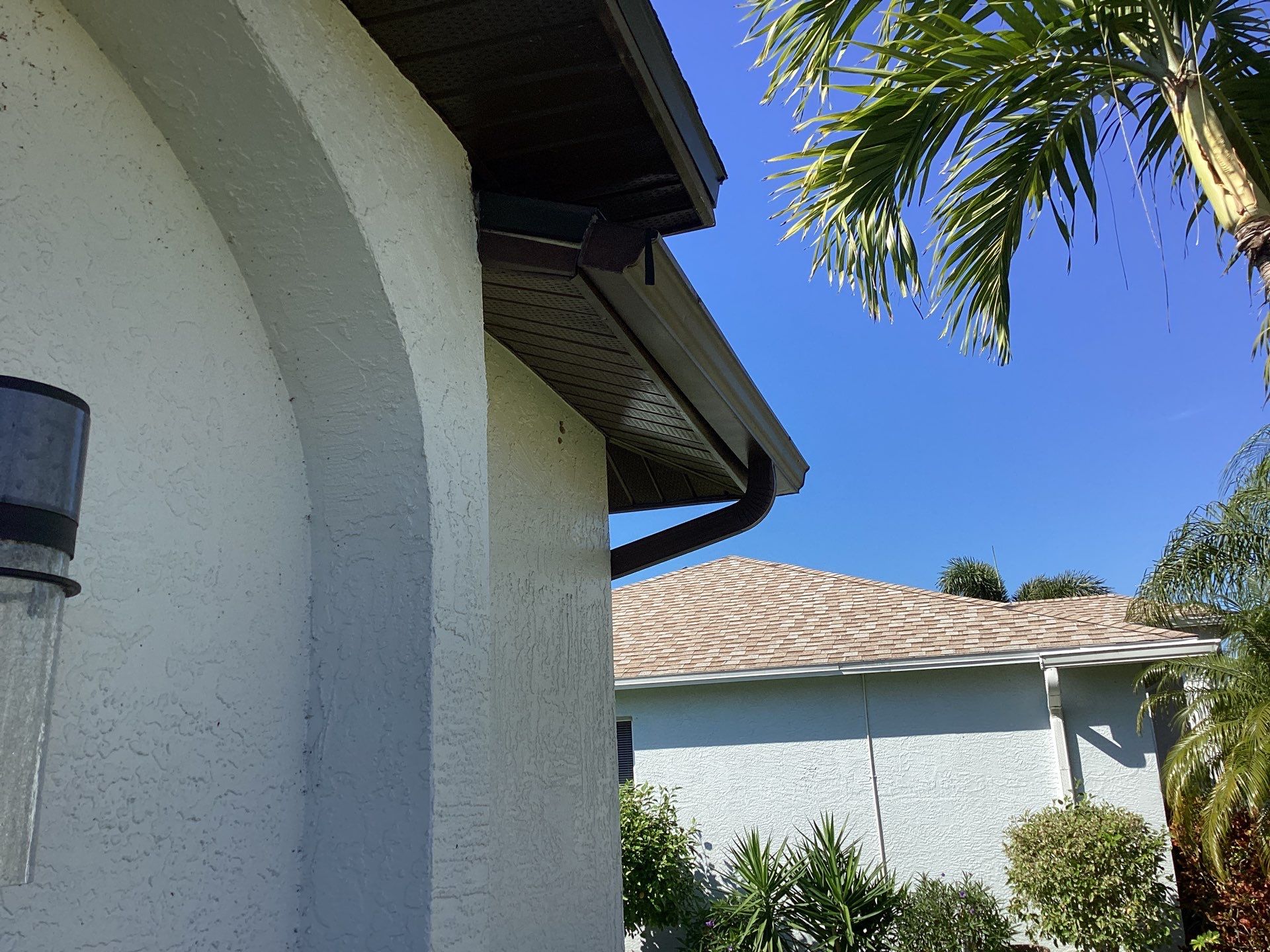 Brown Gutter + White and Brown Downspouts in Cape Coral FL by Gutter Professors
