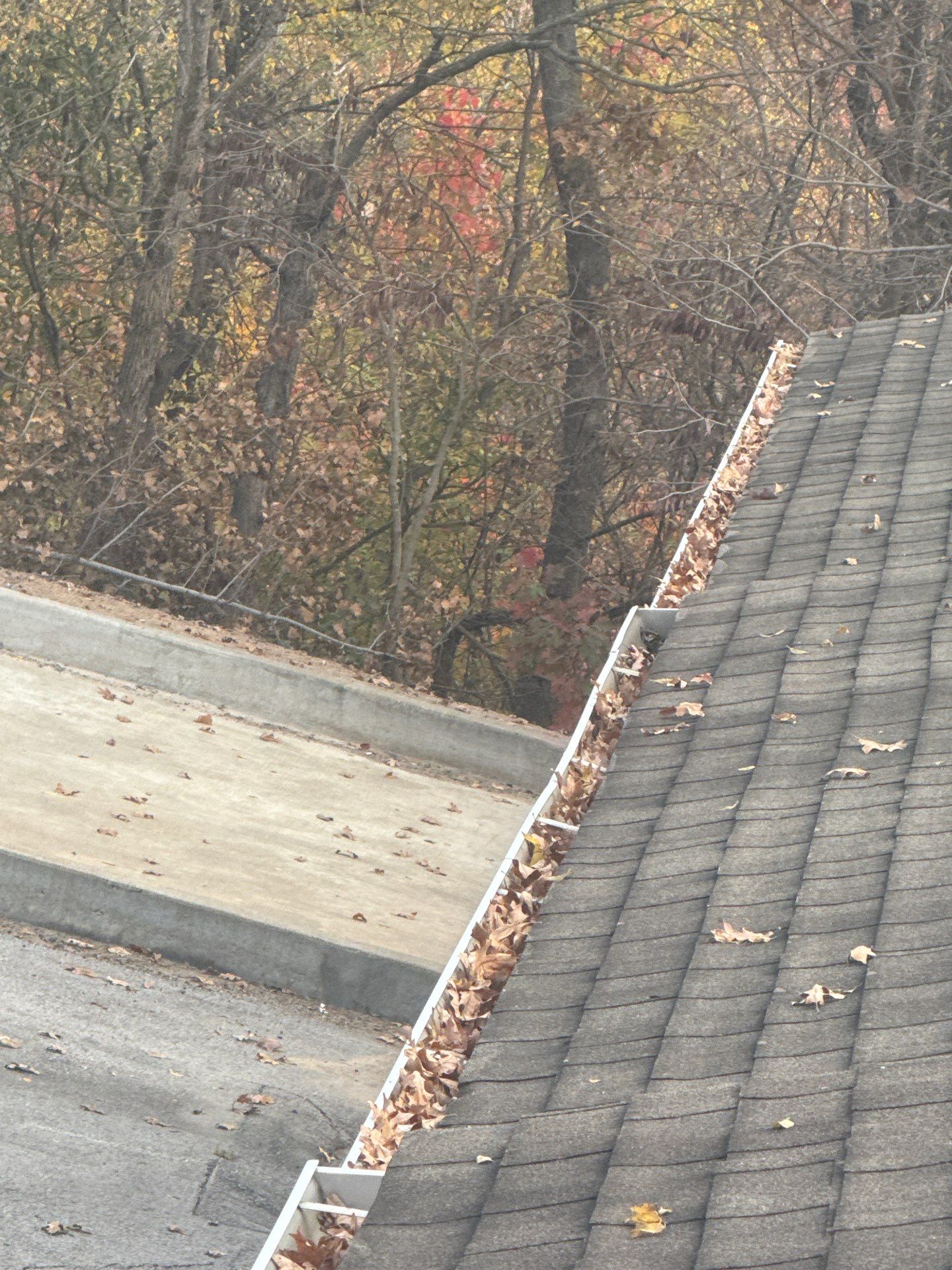 Commercial gutter cleaning Tulsa before photo with filled gutters