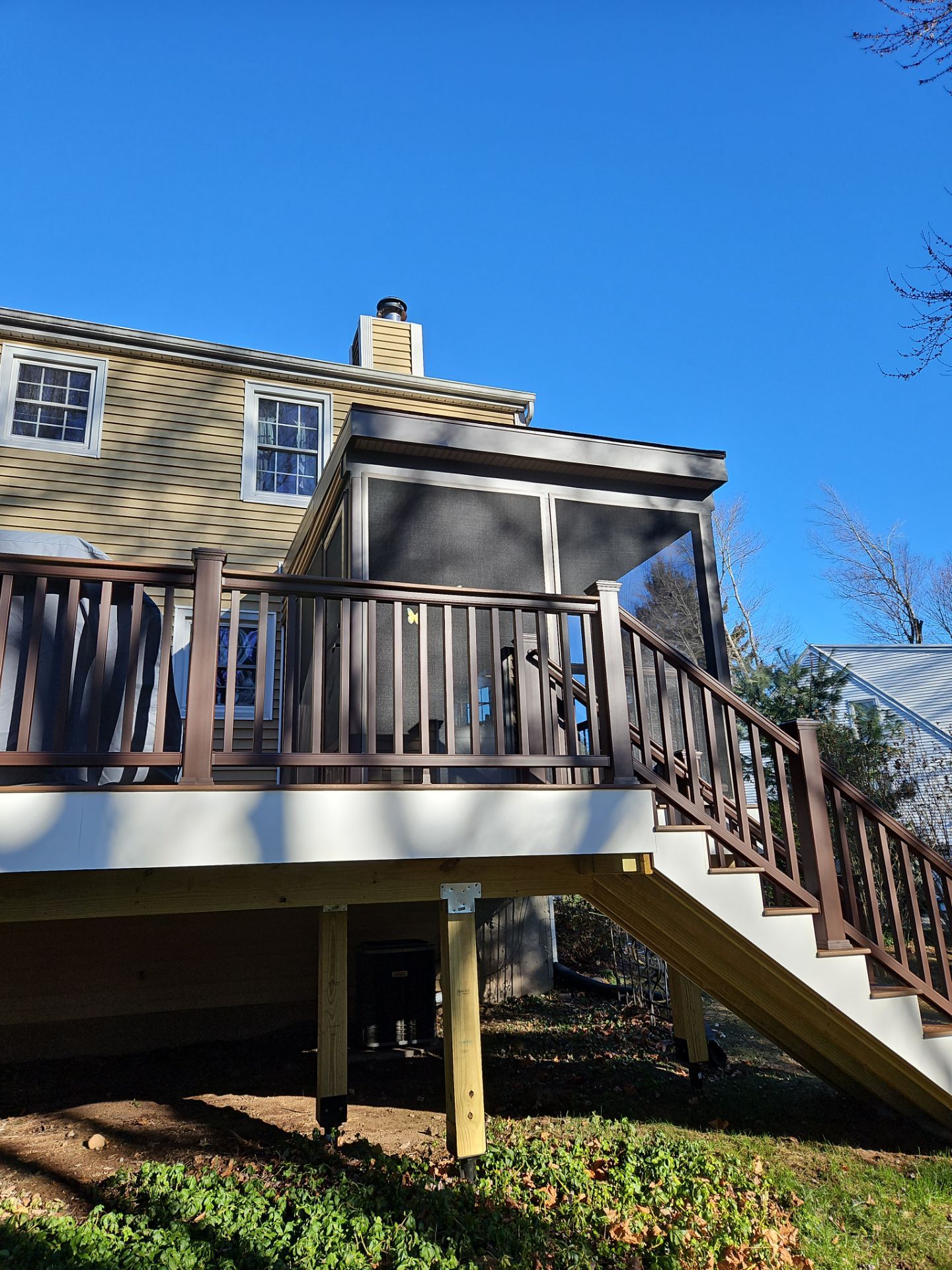 Deck and Screened in room replacement with Trex Saddle and vintage lantern railings by DiGiorgi Roofing and Siding Inc