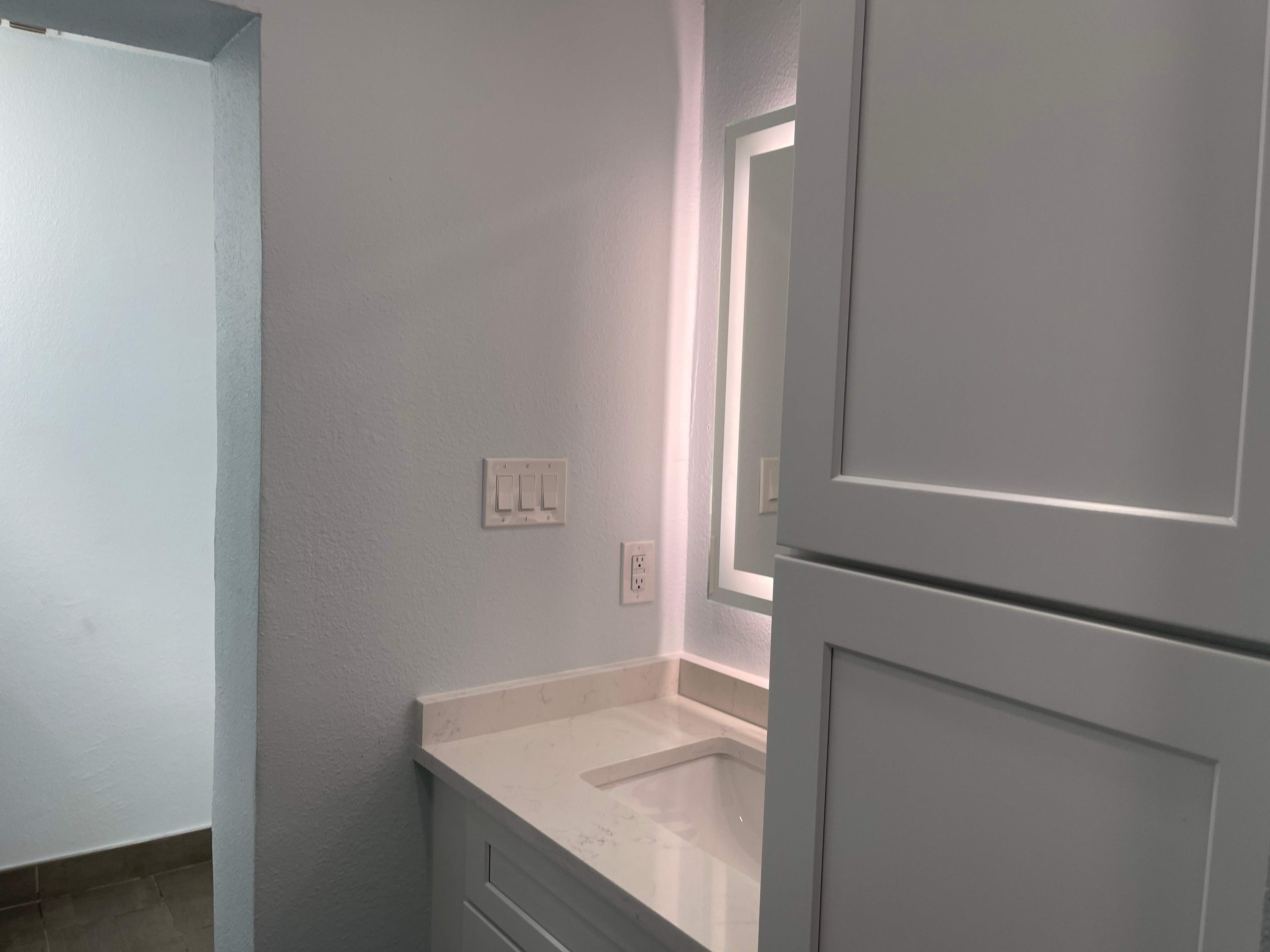 Complete Bathroom Remodel Featuring Marble Tile and Teal Herringbone Niche by Mena stone surfaces