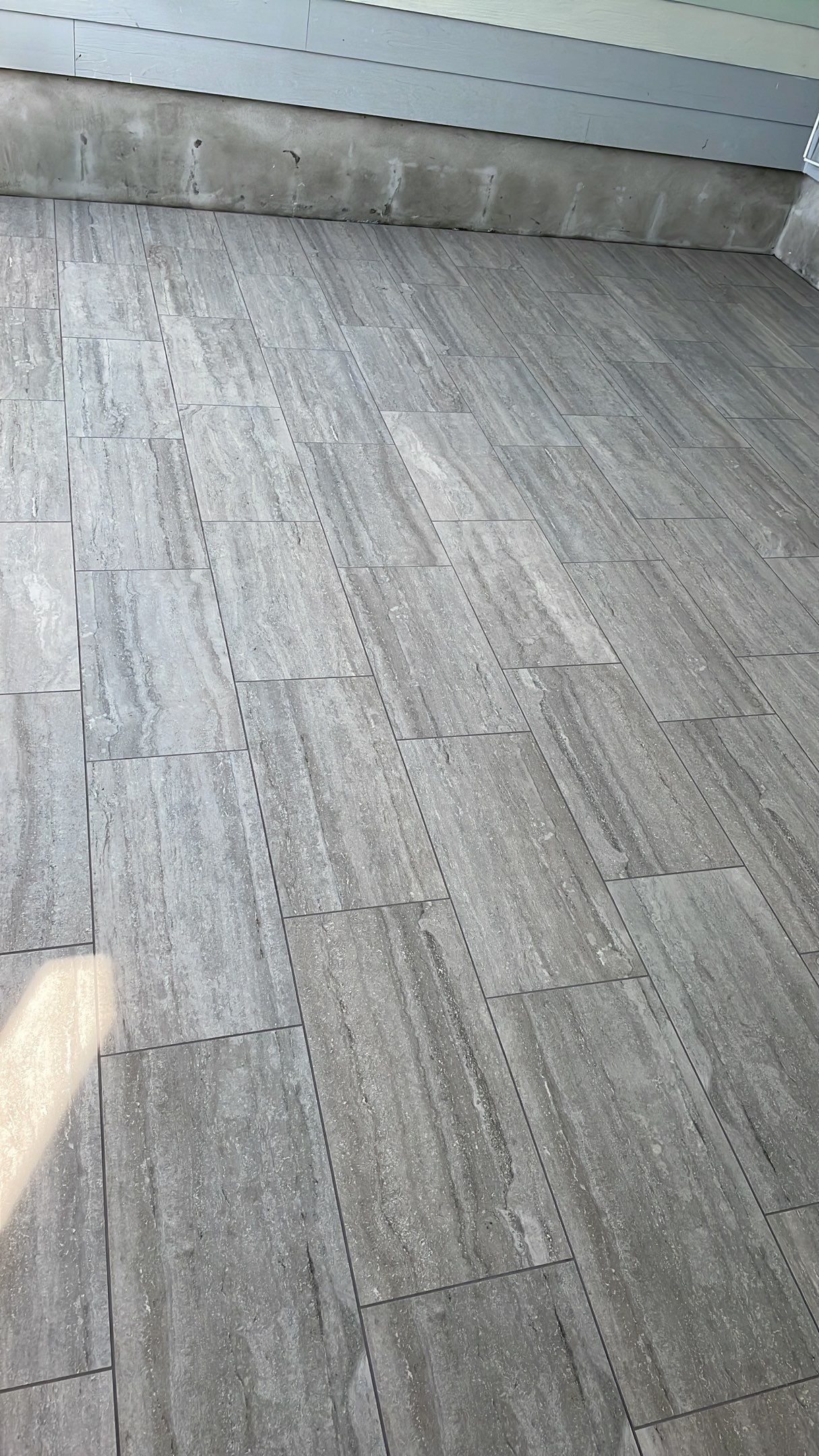 Sunroom using 12x24 tiles by Footprints Floors of Coastal Carolina