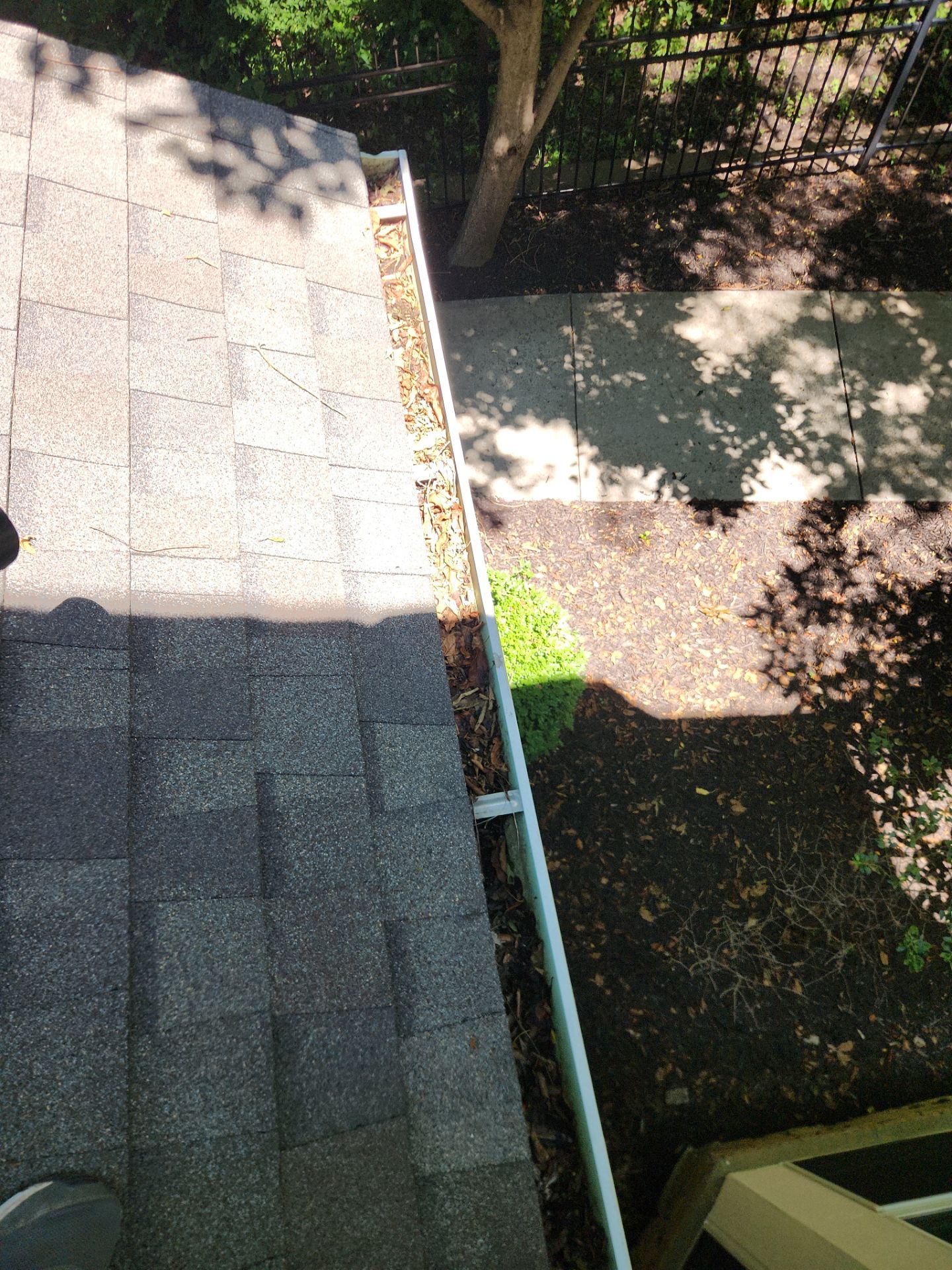 Commercial gutter cleaning Columbia, MO before photo with filled gutters