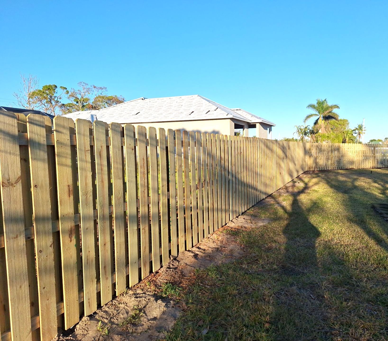 Wood Fence Installation using 6ft Pressure-Treated Wood Board-On-Board Privacy Fence with a 4Ft 3 Rail White Aluminum Fence by Asap fence and gates, LLC