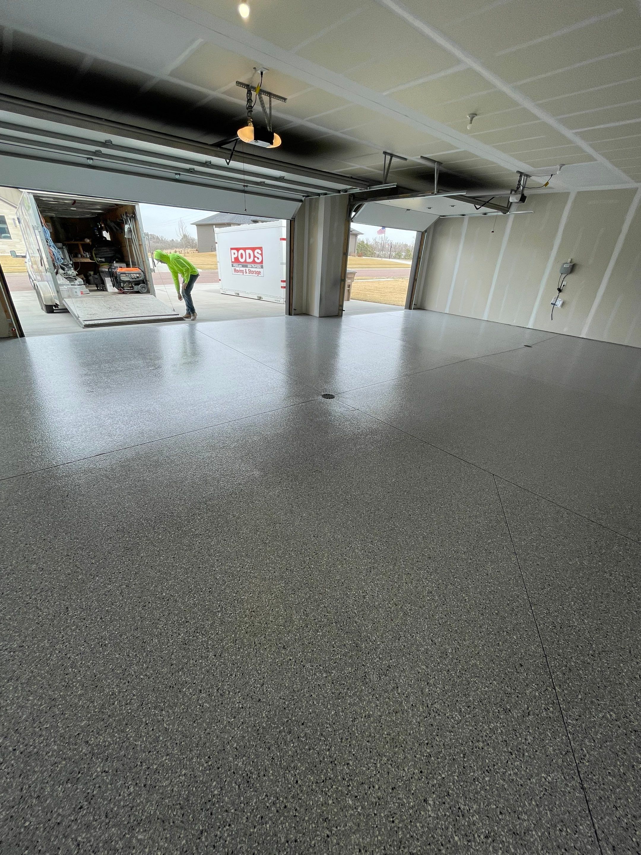 Grey Speckled Epoxy Floor Coating for Sioux Falls Garage by Select Painting, Coatings & Garage Cabinets