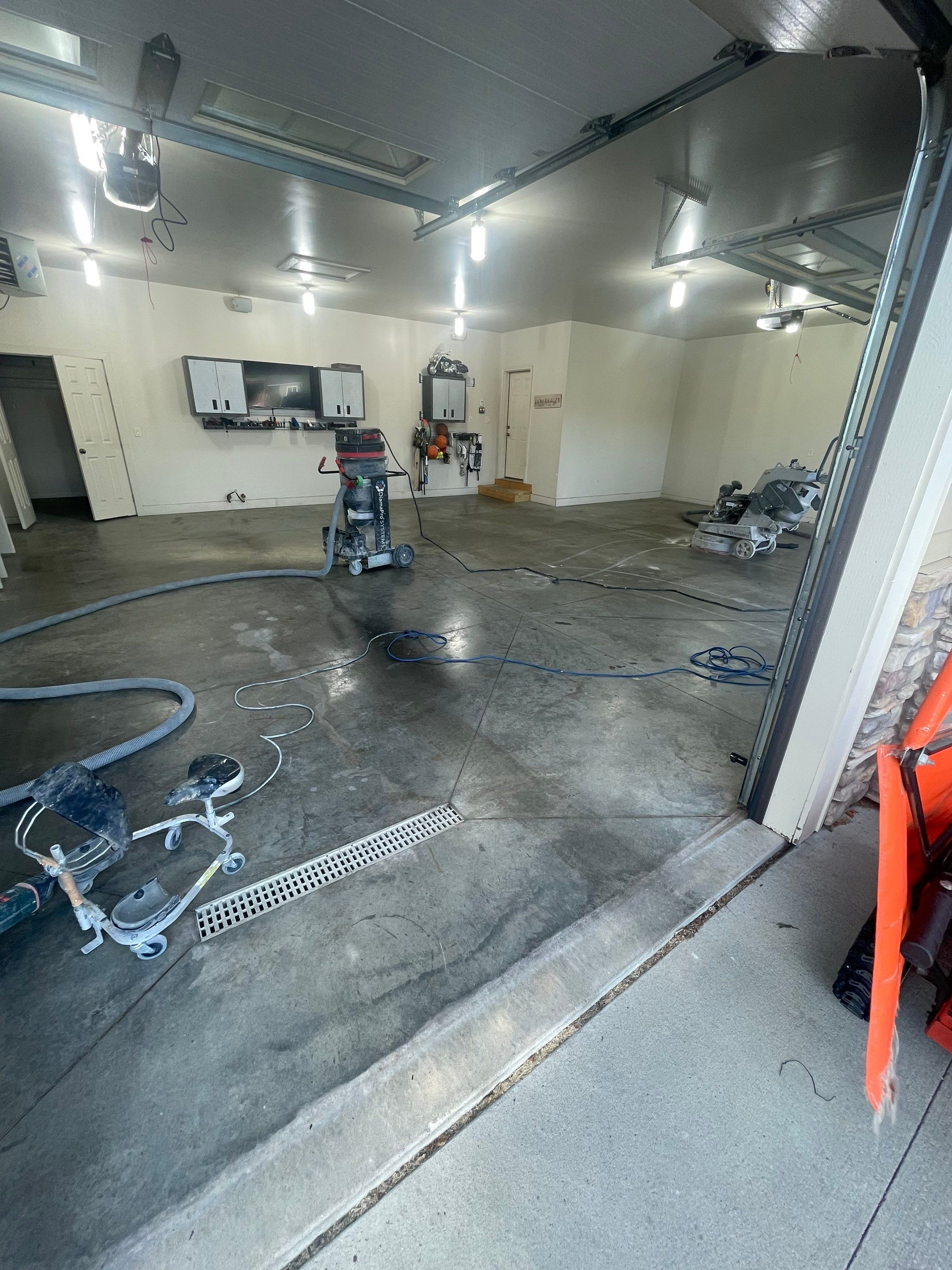Coyote Flake Garage Floor Coating in Sioux Falls with Trench Drain by Select Painting, Coatings & Garage Cabinets