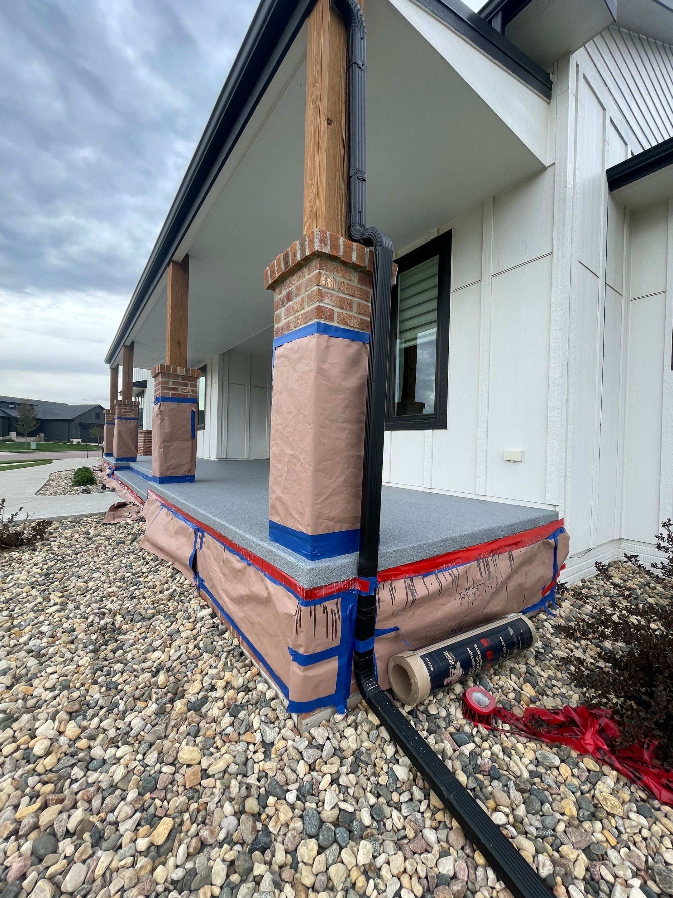Grey Speckled Concrete Porch Coating for Sioux Falls Home by Select Painting, Coatings & Garage Cabinets