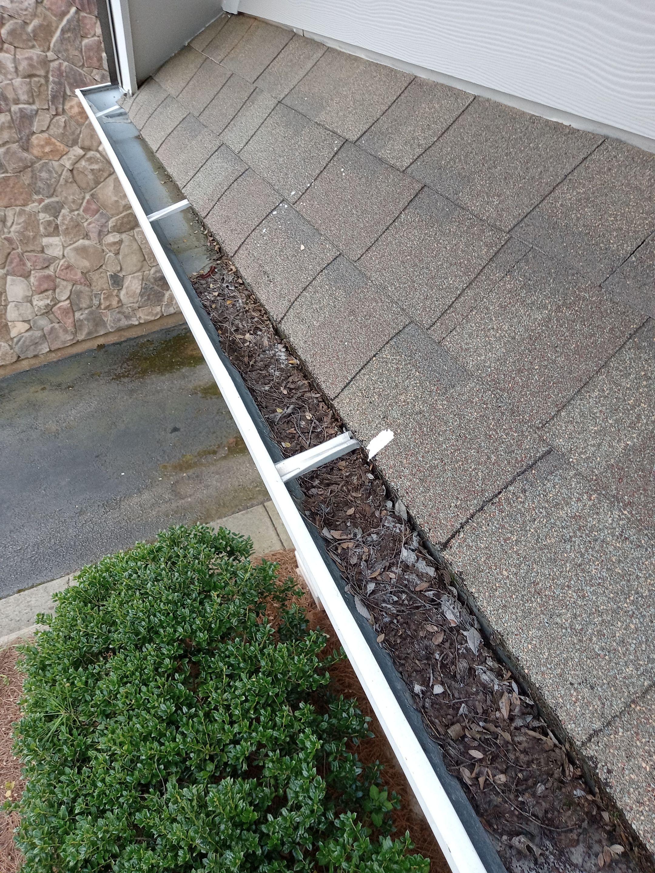 HOA gutter cleaning in Cumming & Forsyth County, GA,before  photo showing full gutters.
