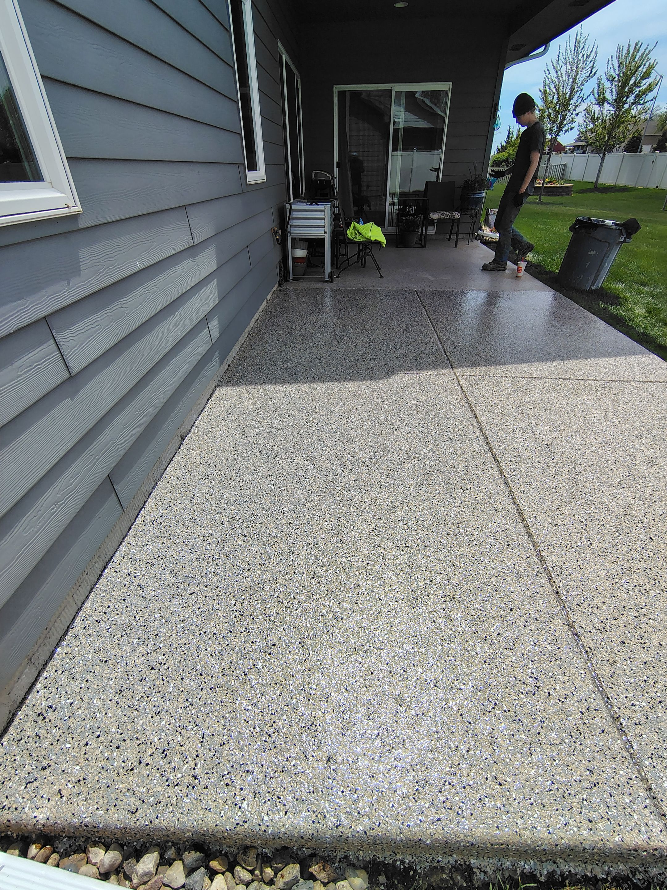 Speckled Concrete Patio Coating Installation in Sioux Falls by Select Painting, Coatings & Garage Cabinets