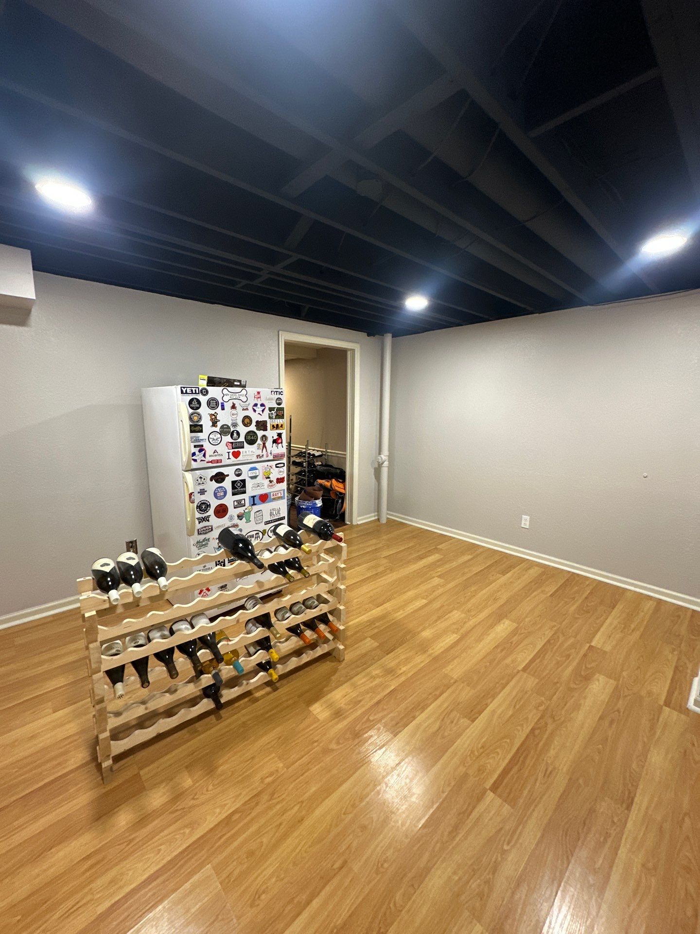 Basement Remodel with Exposed Painted Ceilings and Laminate Flooring in Mequon by OCS Contracting Services