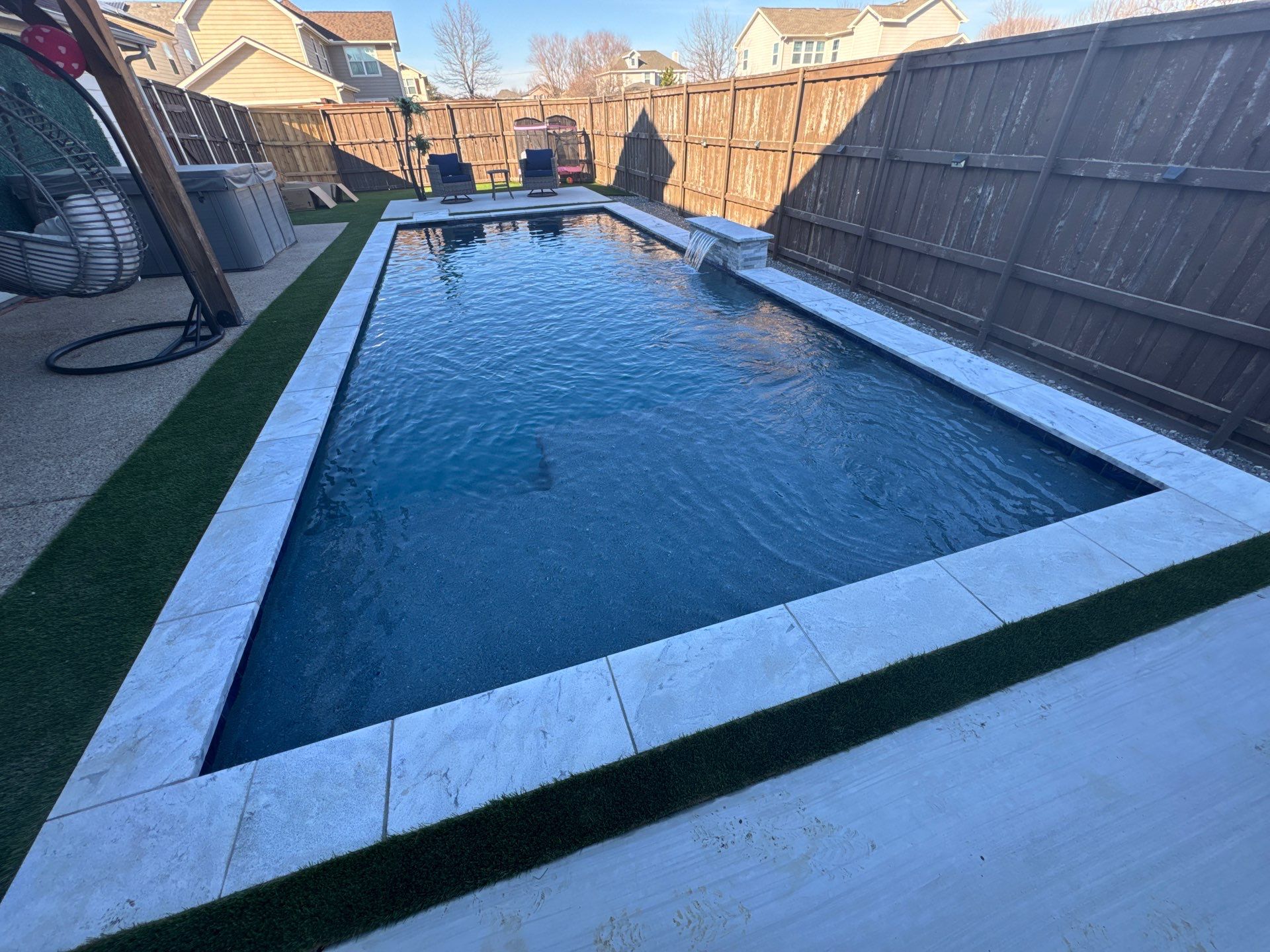 Pool with Turf and Raised Wall by Pinnacle Pools and Spas - DFW