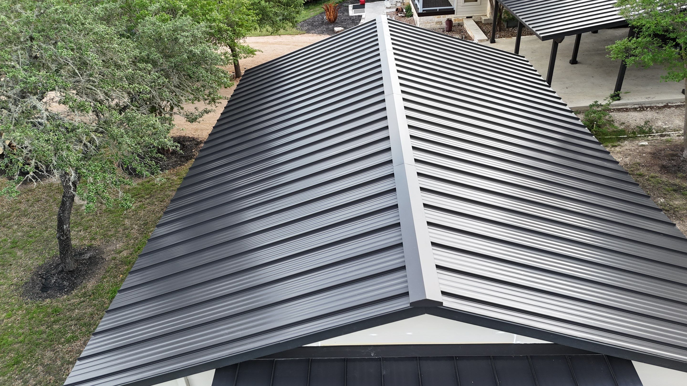 Dark Bronze Fully Striated panel by Wimberley Roofing
