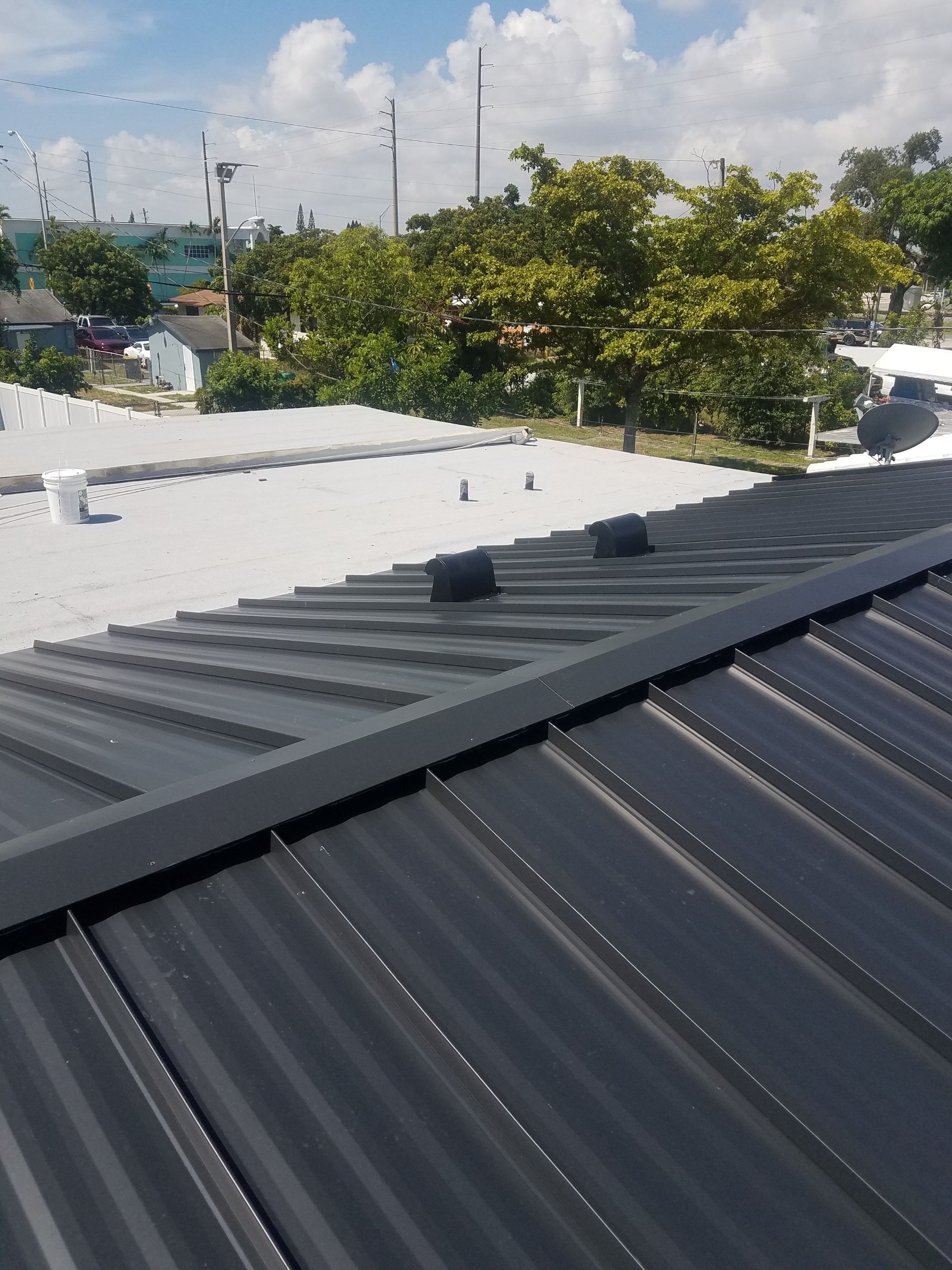 Standing Seam Metal & Flat Re-Roof using 1.5" Nail Strip 24ga Black Matte Kynar Coated Standing Seam Metal Panels by Morton Roofing, Inc.