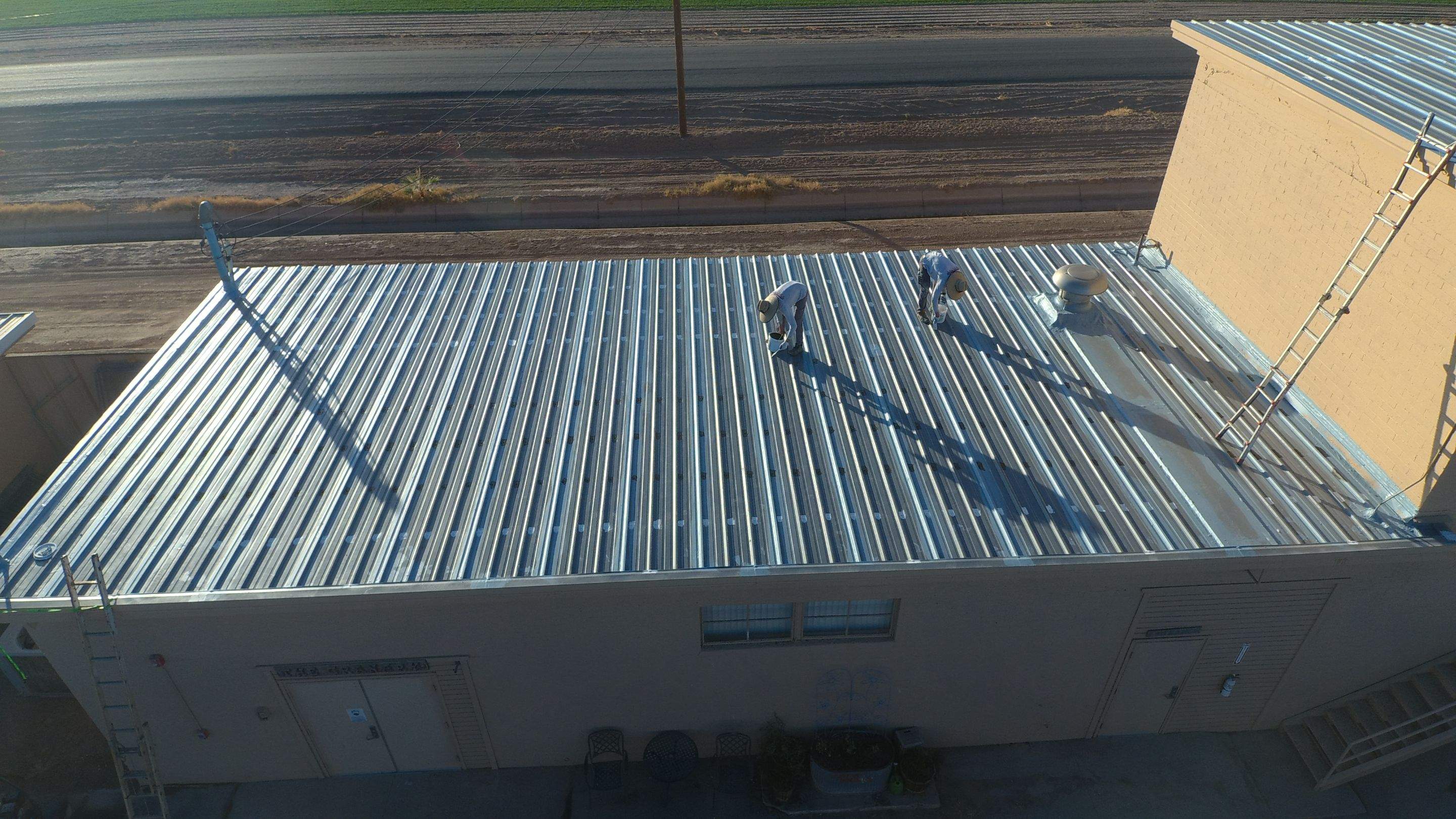 Metal roof restoration on commercial roof using Conklin Benchmark/PUMA XL fabric and coating by Straight Edge Roofing Inc