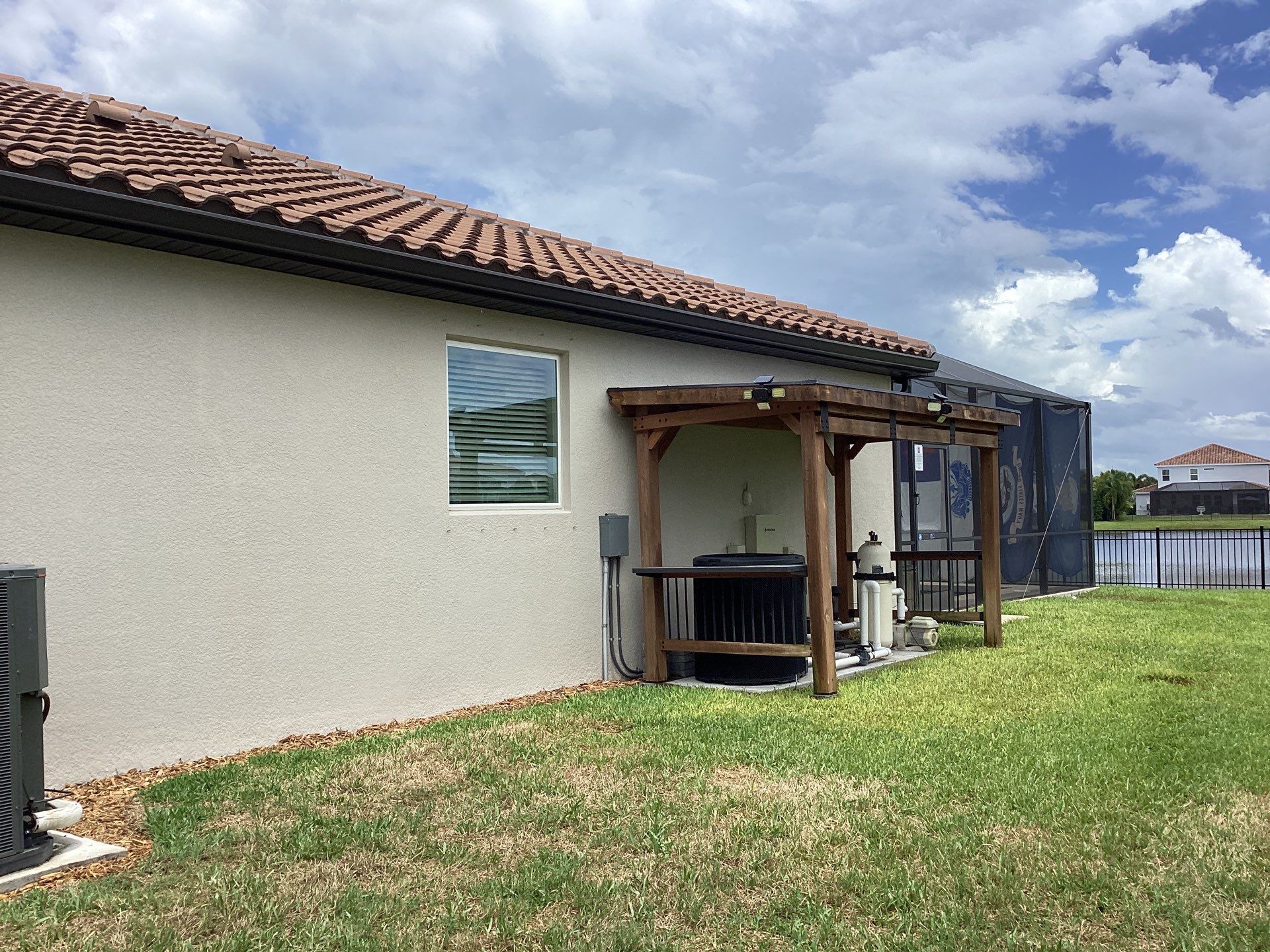 Musket brown seamless gutters with splash guards, new downspouts, and extensions in Bradenton, FL by Gutter Professors