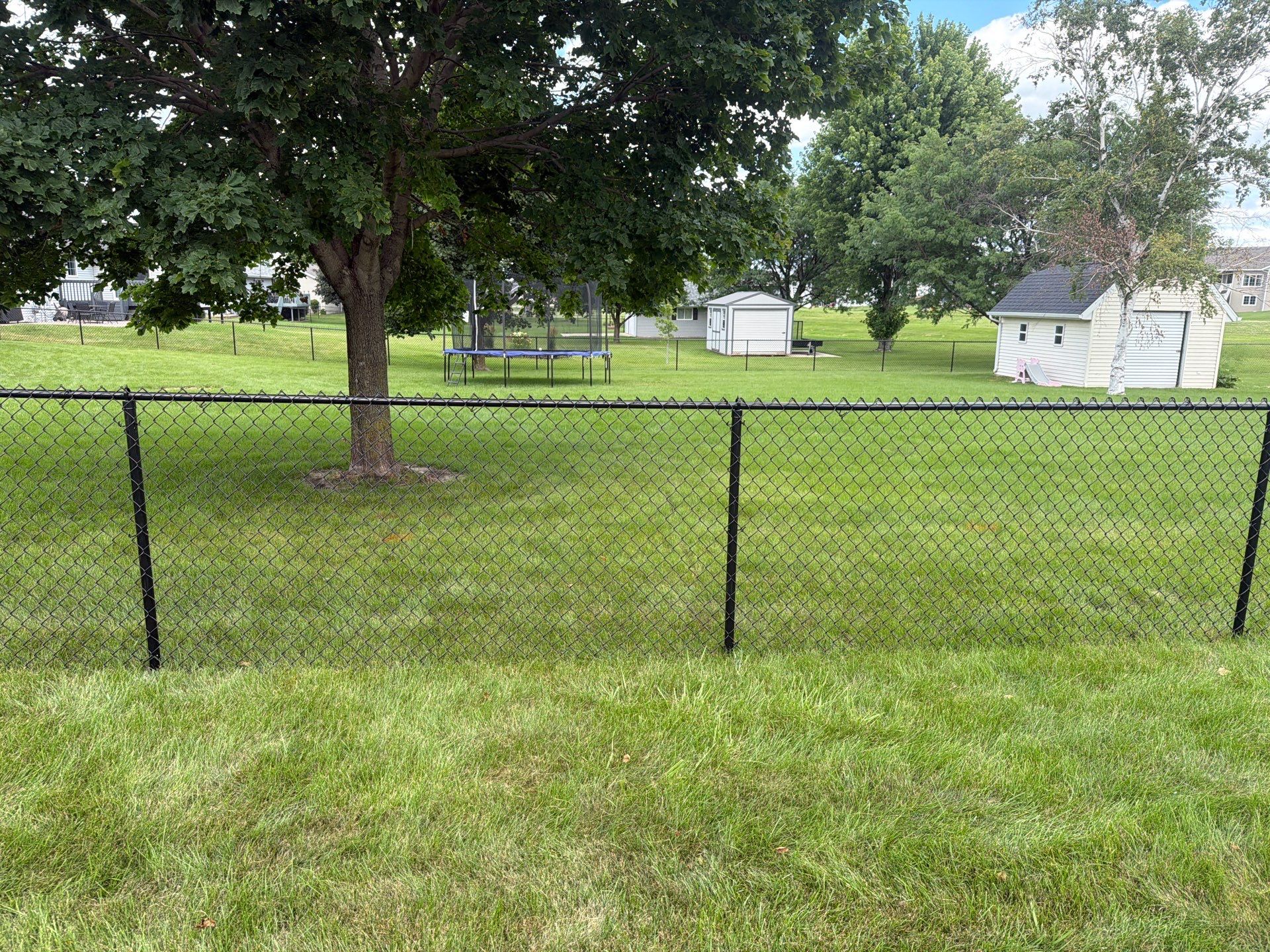 Black Vinyl-Coated Chain Link Fence Installation in Fairbank by Perfect Picket Fence and Stain