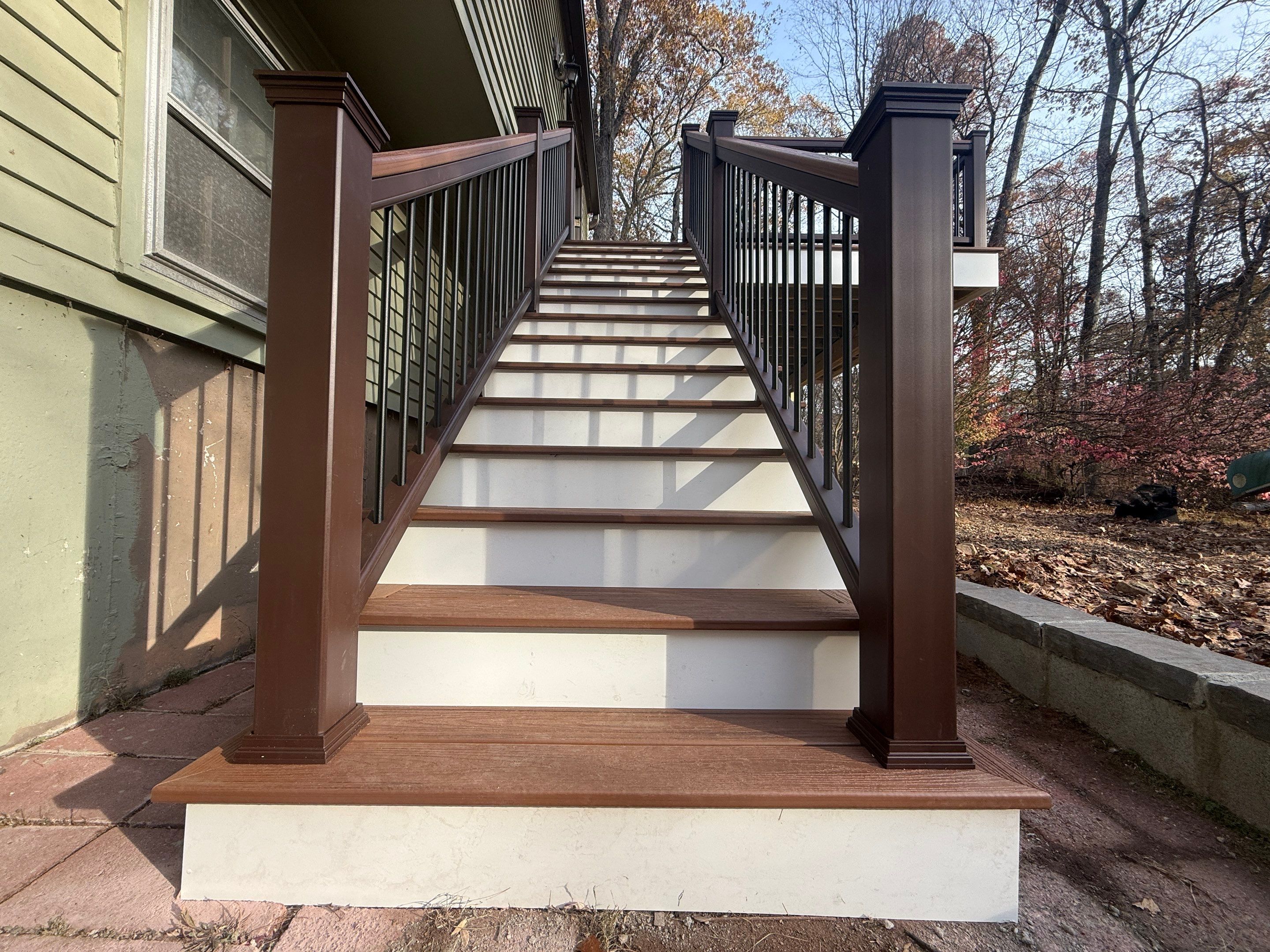 Replacement deck with Trex Tropical Tiki torch and Transcend Cocktail railings in vintage lantern. by DiGiorgi Roofing and Siding Inc