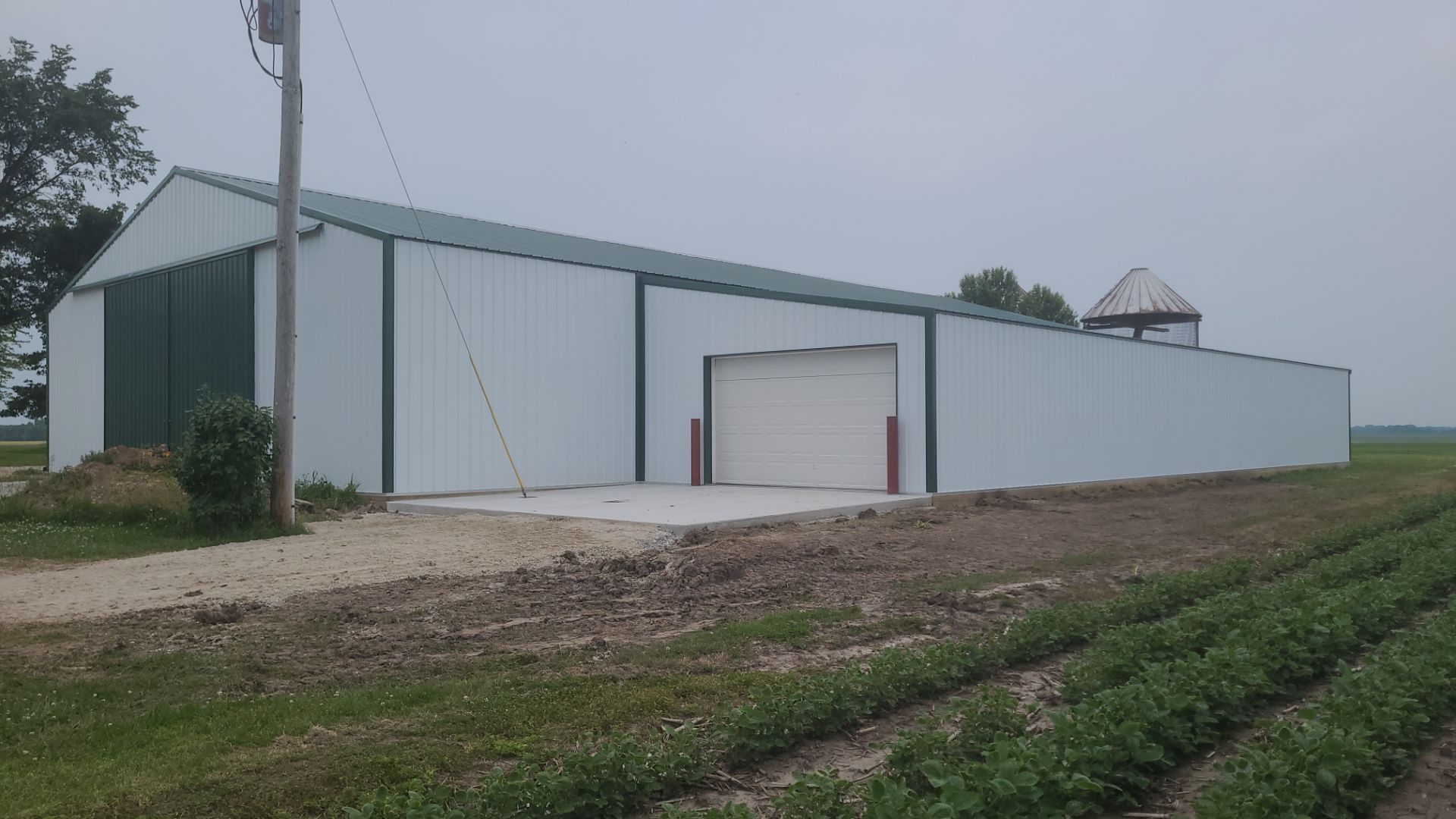 Reskin pole barn and add lean-to