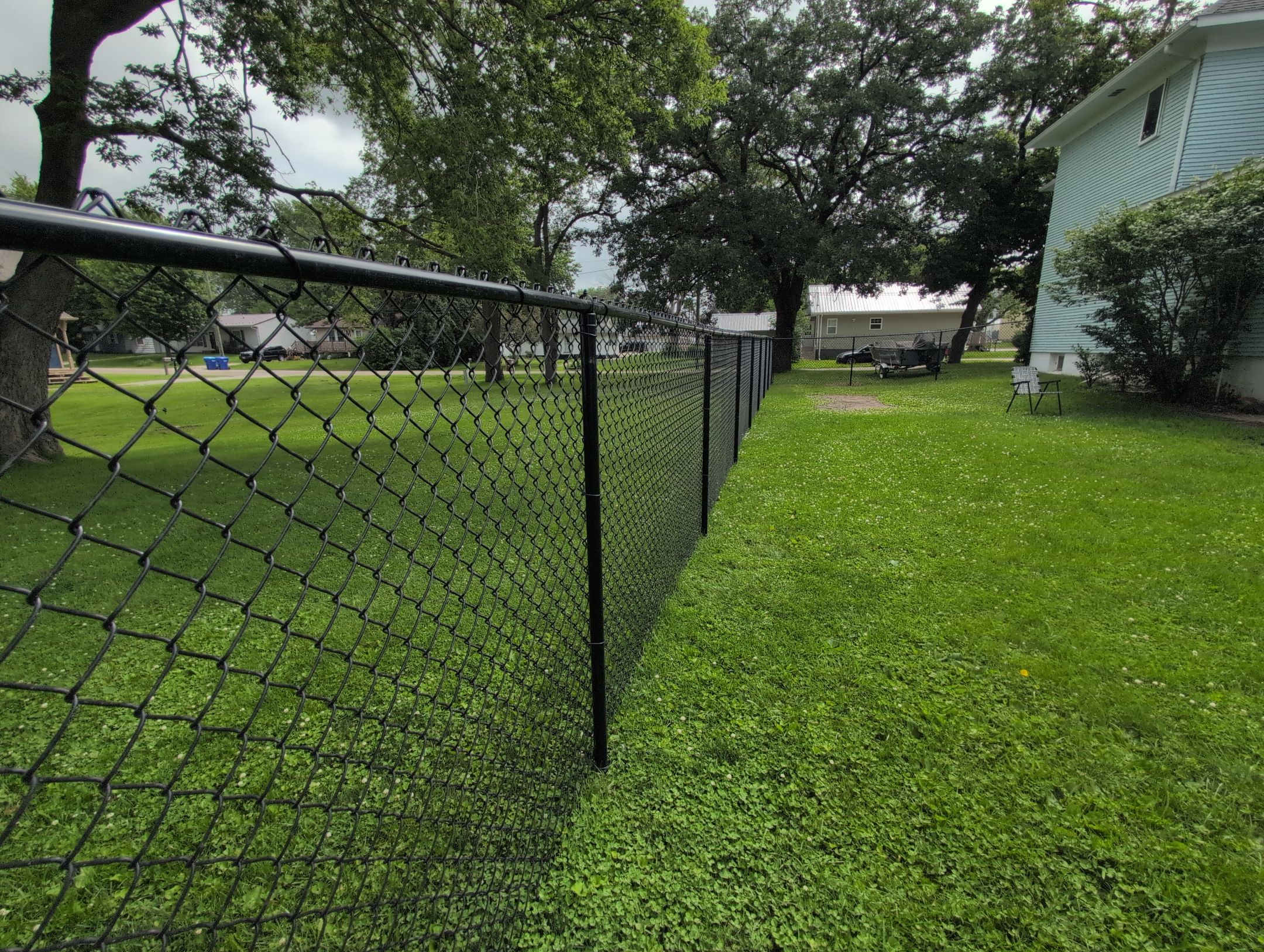 Black Vinyl Coated Chain Link Fence Installation in Independence by Perfect Picket Fence and Stain