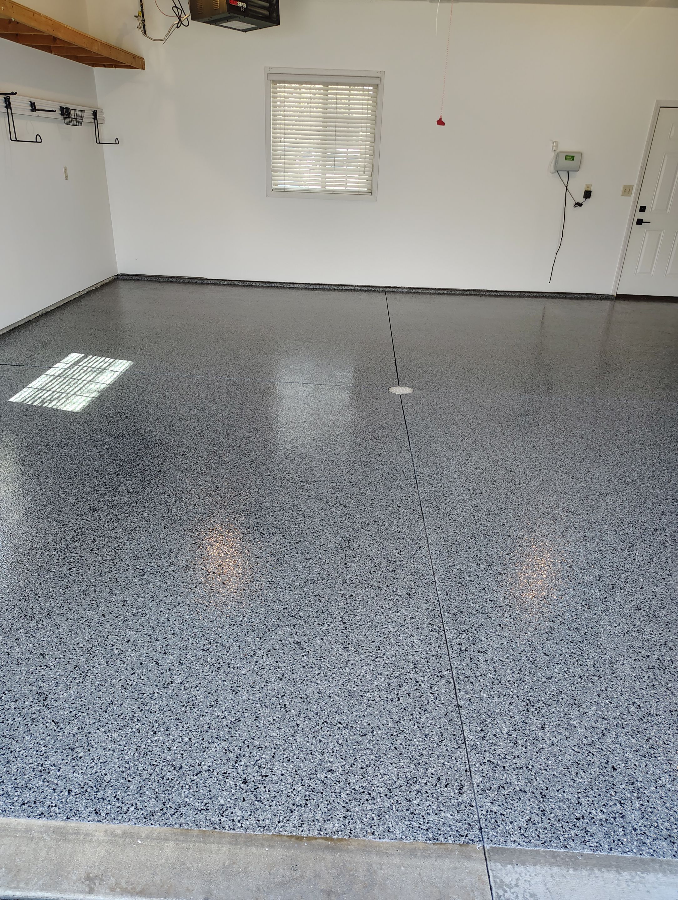 Grey Speckled Epoxy Garage Floor Coating in Sioux Falls by Select Painting, Coatings & Garage Cabinets