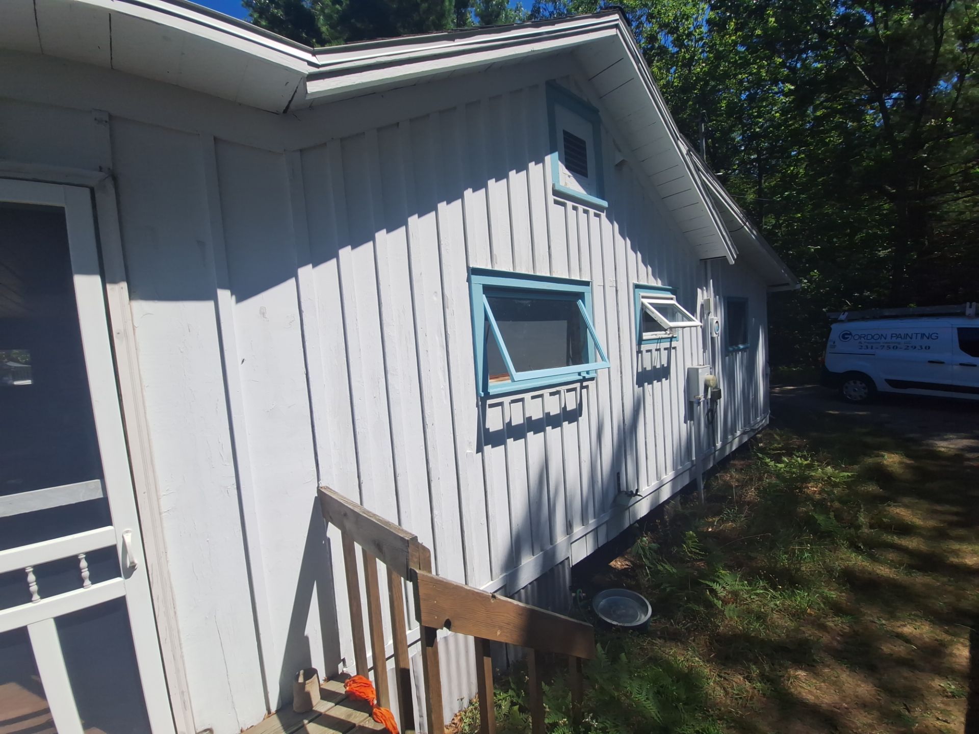 Lakeside Cottage Exterior Painting and Teal Trim Restoration in Mears by Gordon Painting