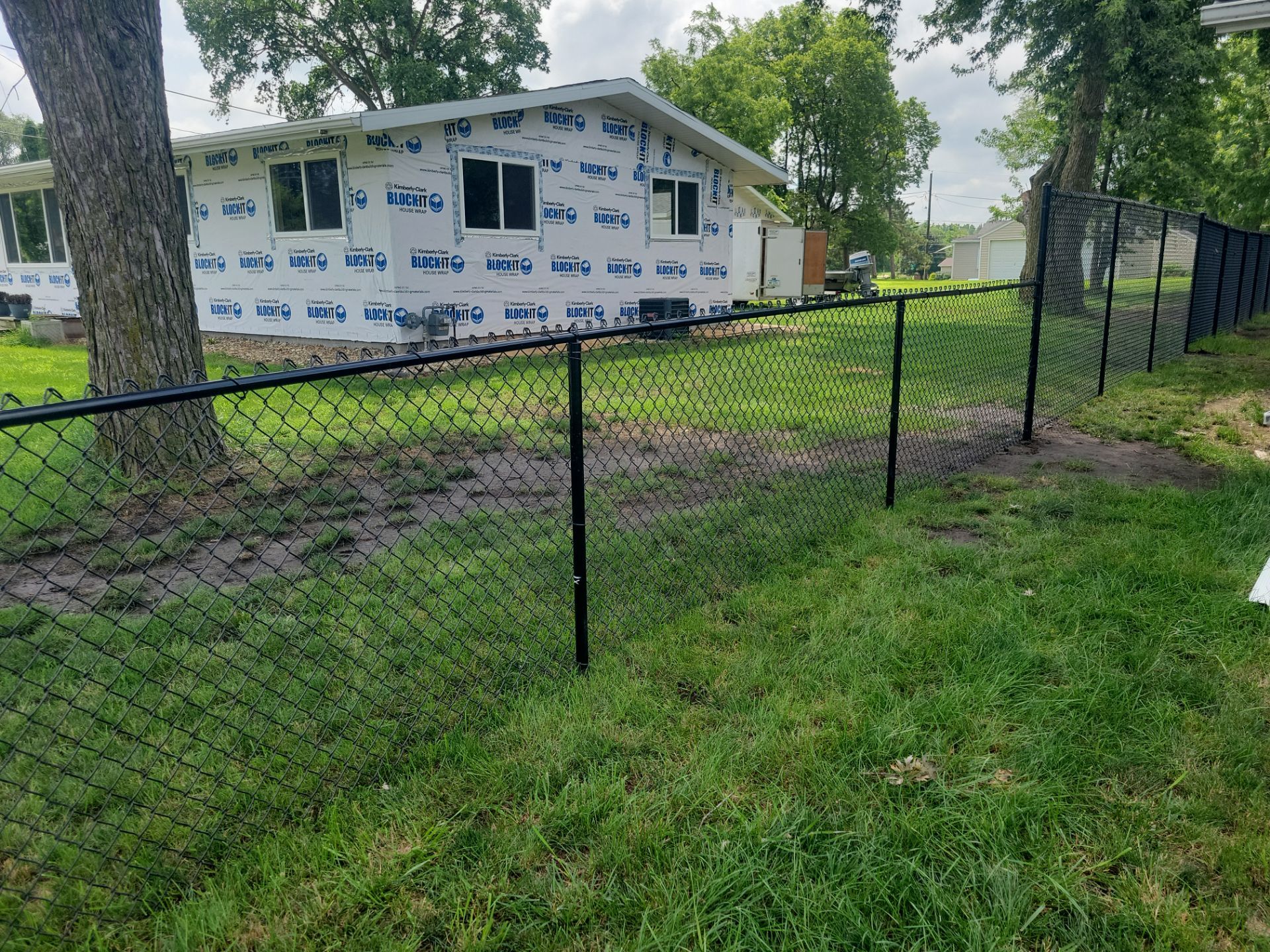 Black Chain Link Perimeter Fence Installation in Waterloo by Perfect Picket Fence and Stain