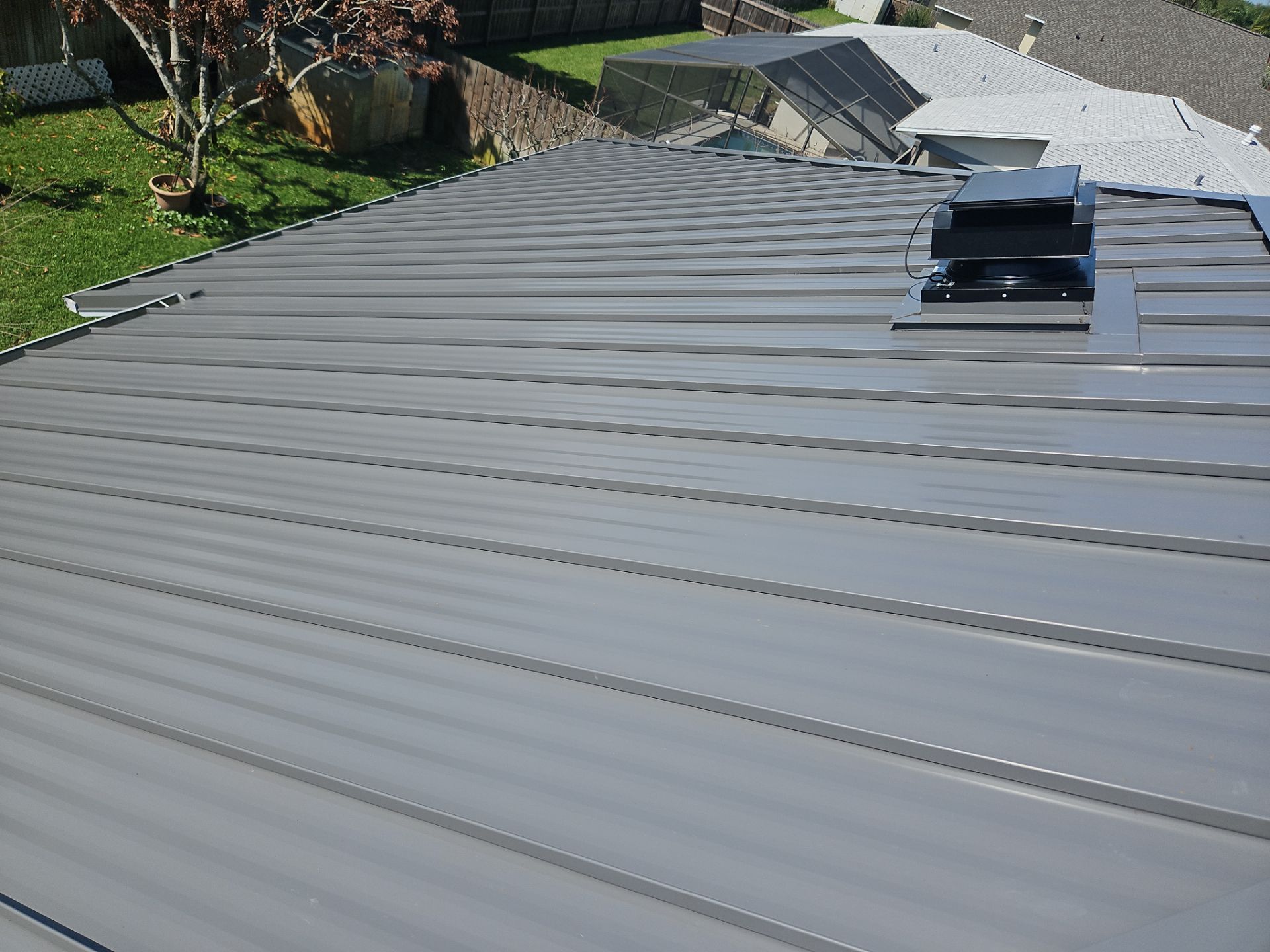 Complete Metal Roof Replacement and Seamless Gutter Installation in Melbourne by Wiedmann Construction & Roofing