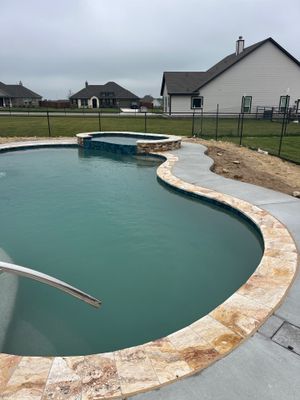Freeform Pool with Raised Spa and Travertine Decking