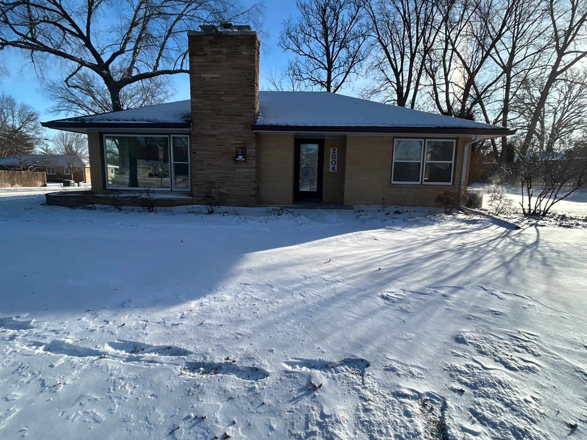 Black-Frame Pella Lifestyle Upgrade on a Partial Brick Home by United Windows and Siding LLC