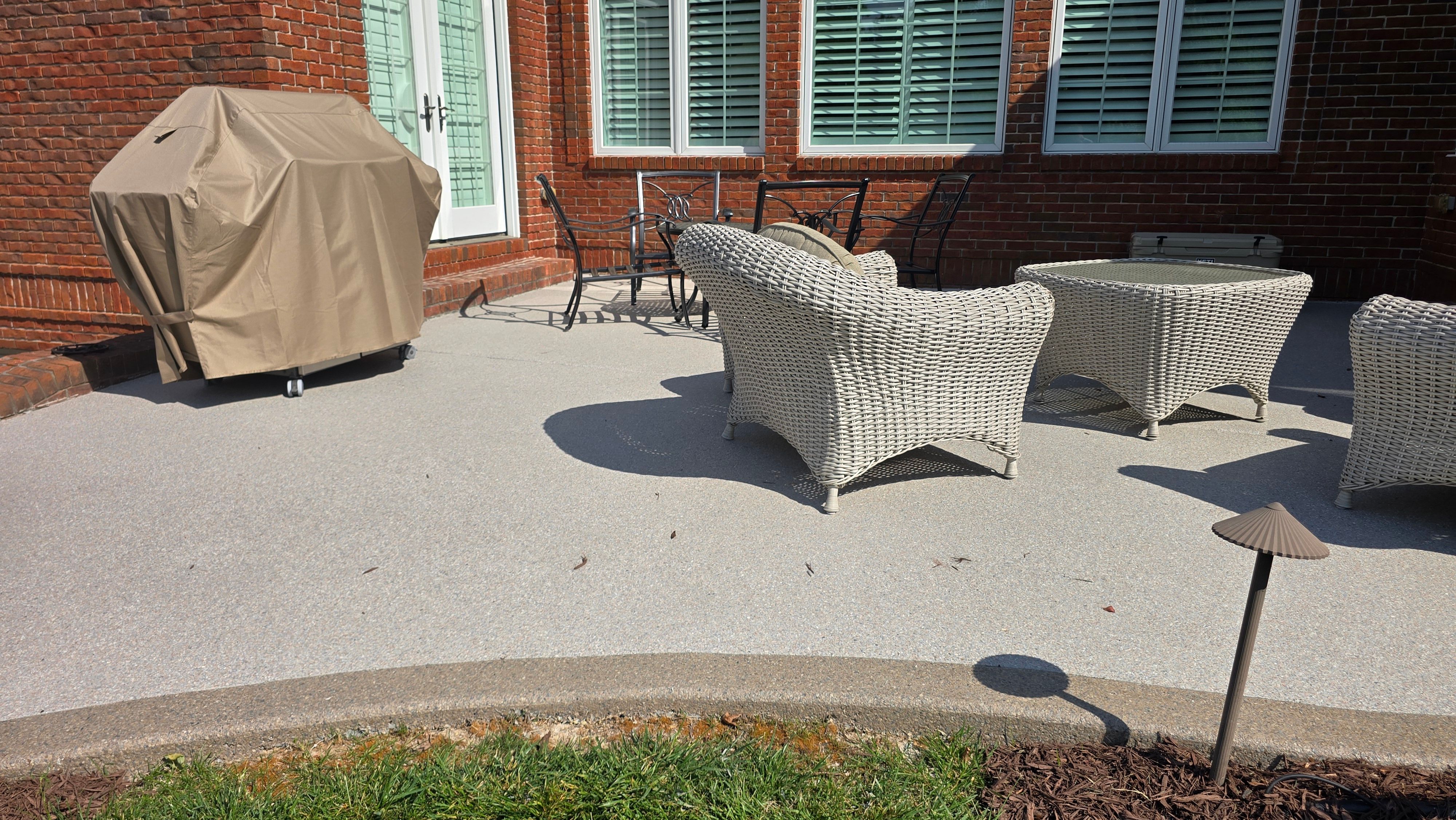 Patio in Pumice with Obsidian Border  by Elite Floor Solutions