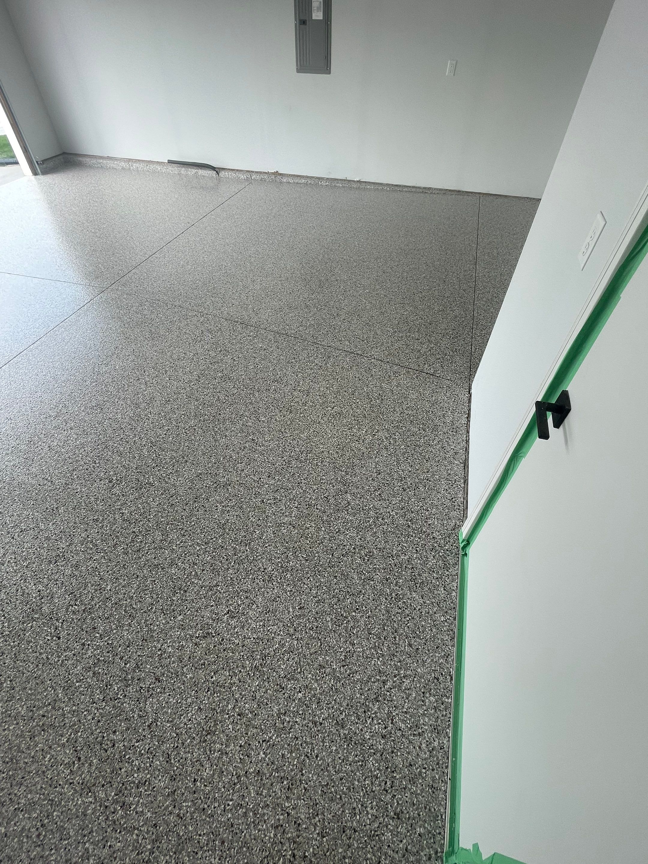 Custom Coyote Flake Garage Floor Coating in Sioux Falls by Select Painting, Coatings & Garage Cabinets