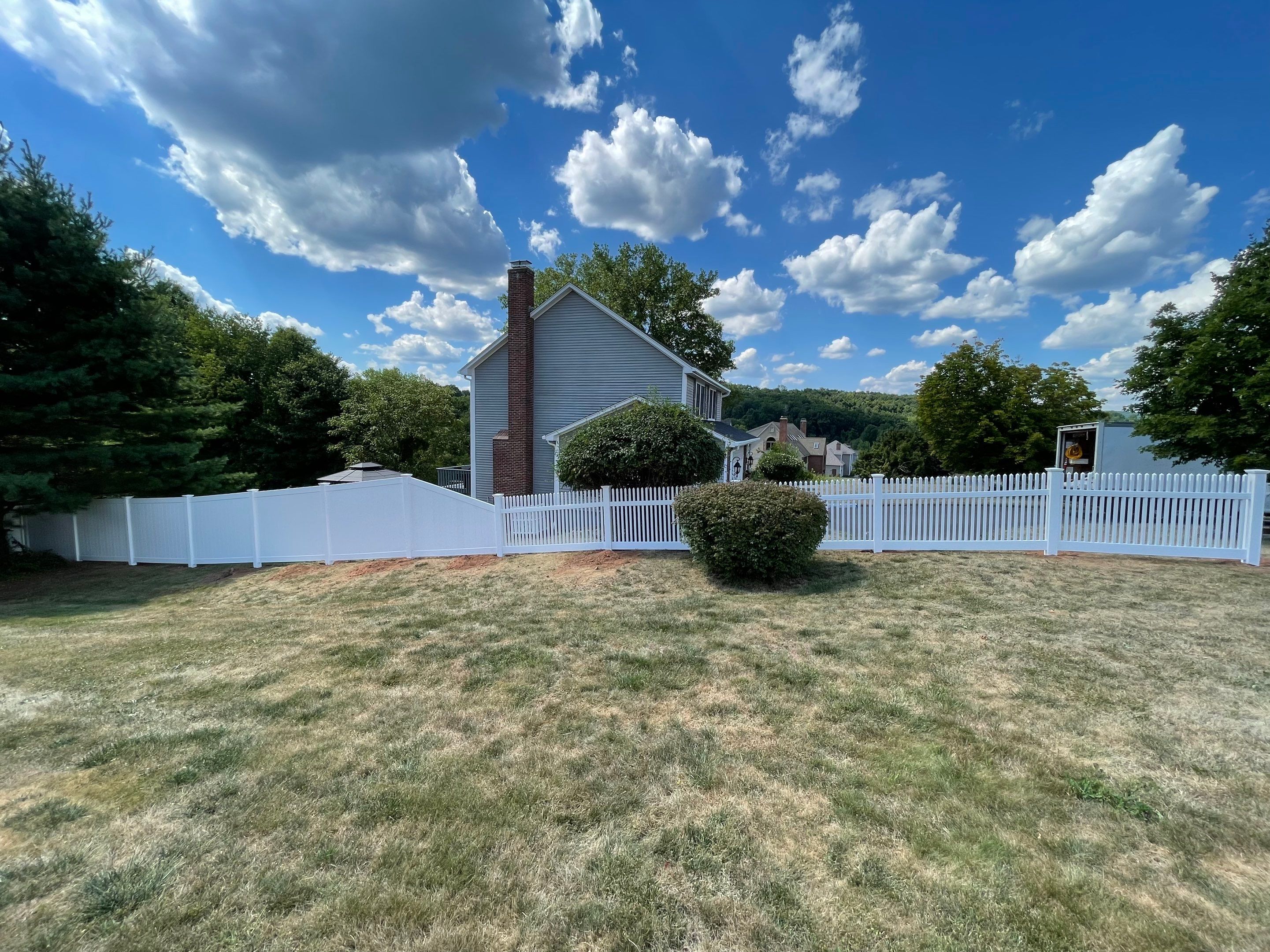 New Vinyl privacy fence and picket fence in white by DiGiorgi Roofing and Siding Inc
