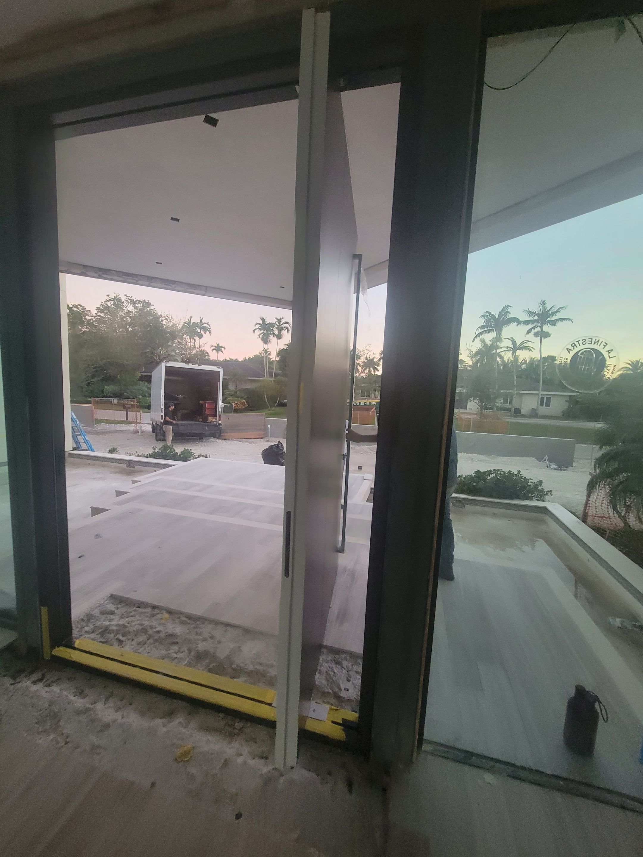 Custom Material Pivot Door installation by Impact Precious Wood Inc.