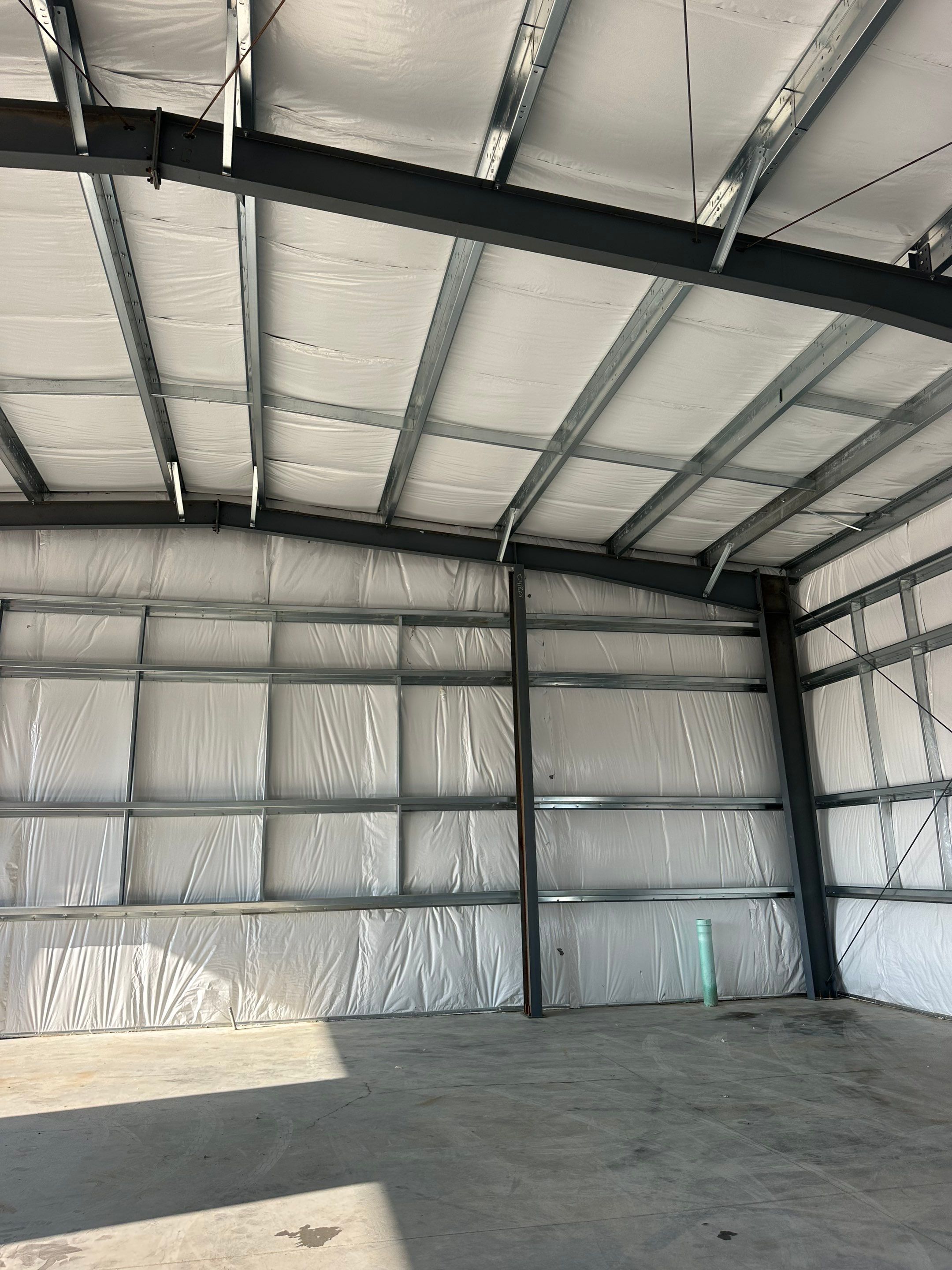 Dark Green Metal Siding by Reimagine Roofing