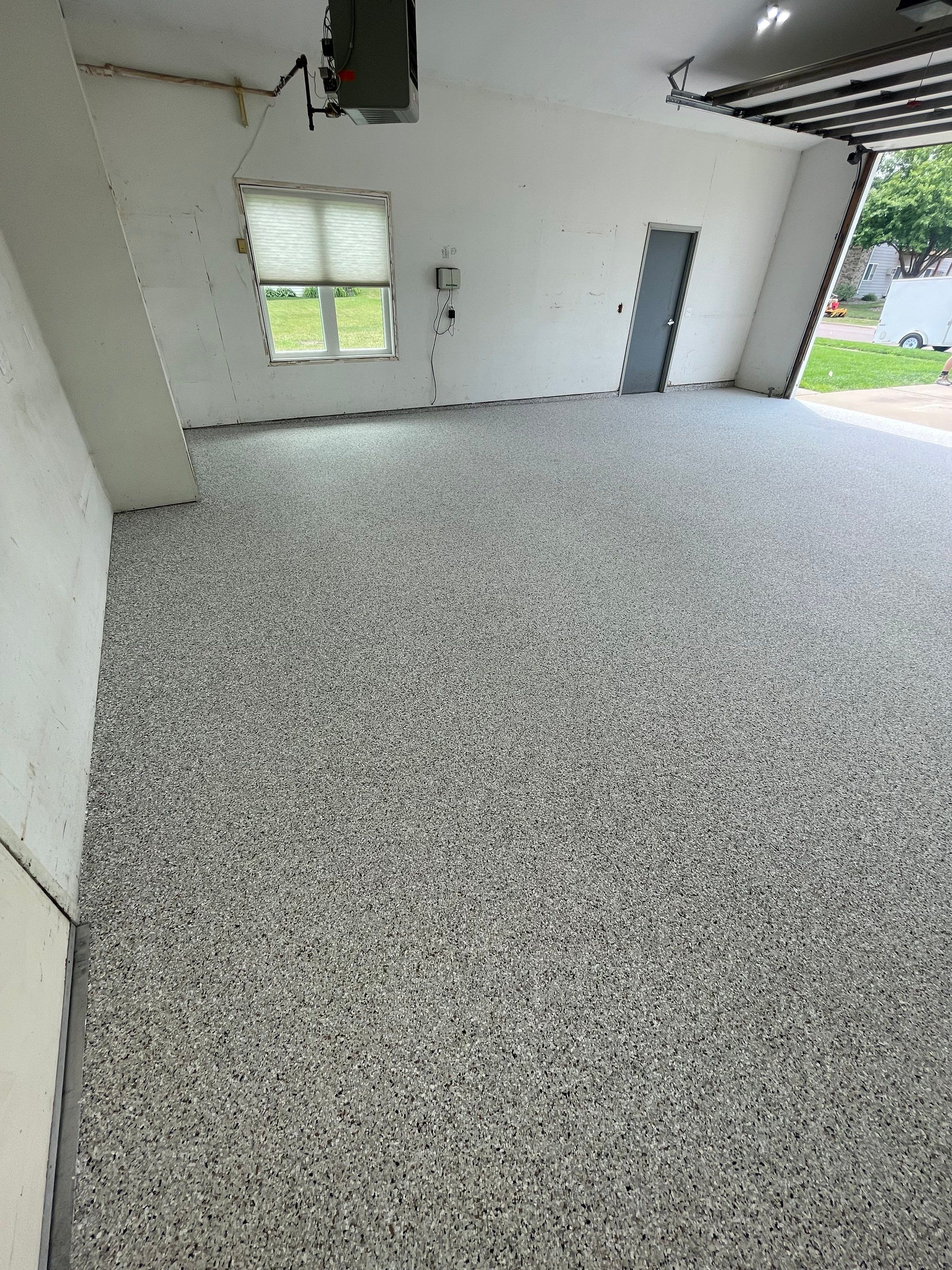 Coyote Flake Concrete Coating for Sioux Falls Garage by Select Painting, Coatings & Garage Cabinets