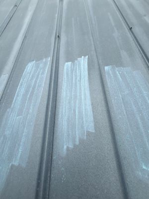 Close up of metal roof panel with chalk markings