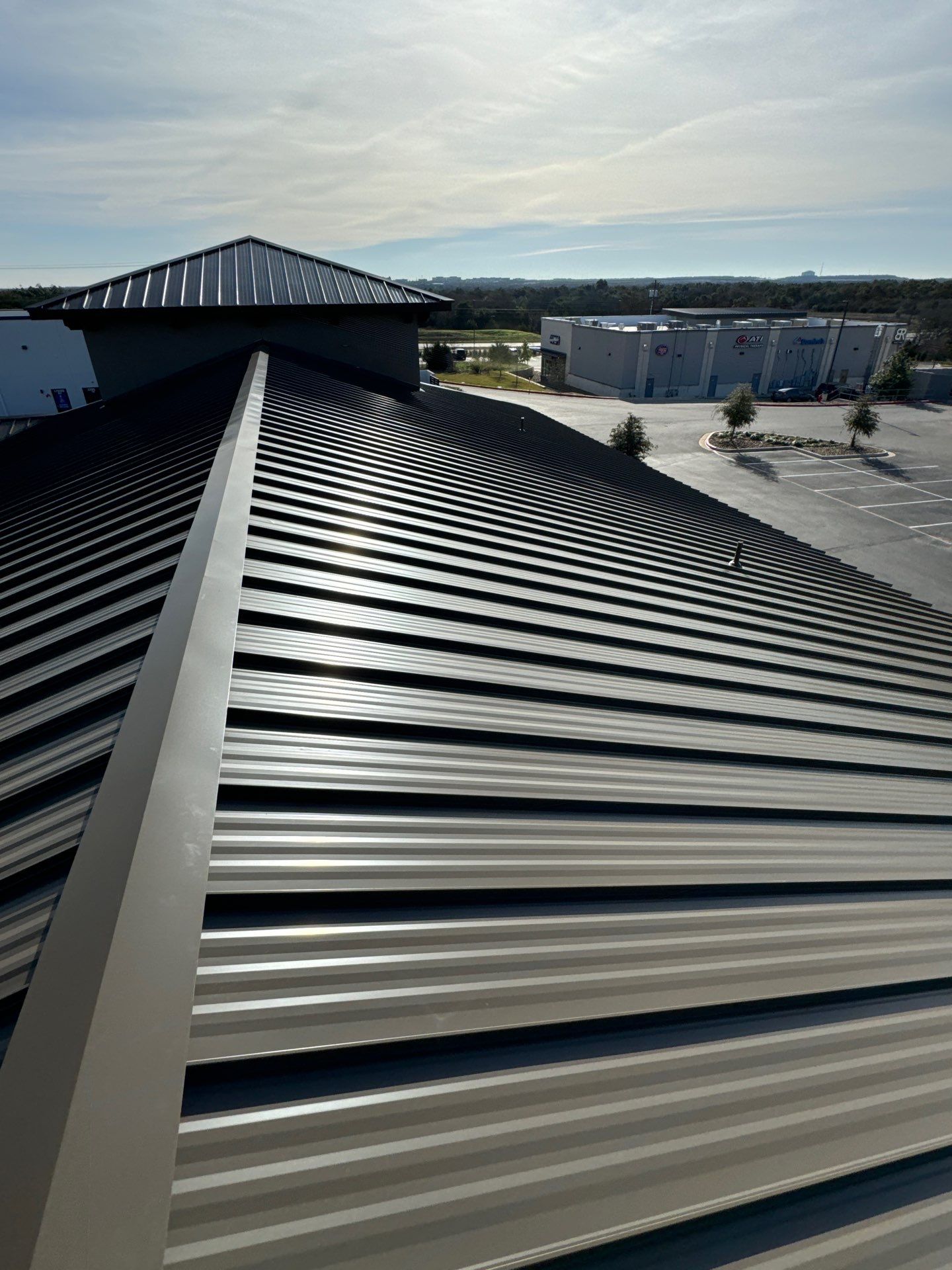Commercial Roofing Installation using 24 GA Standing Seam by Action Exteriors Austin