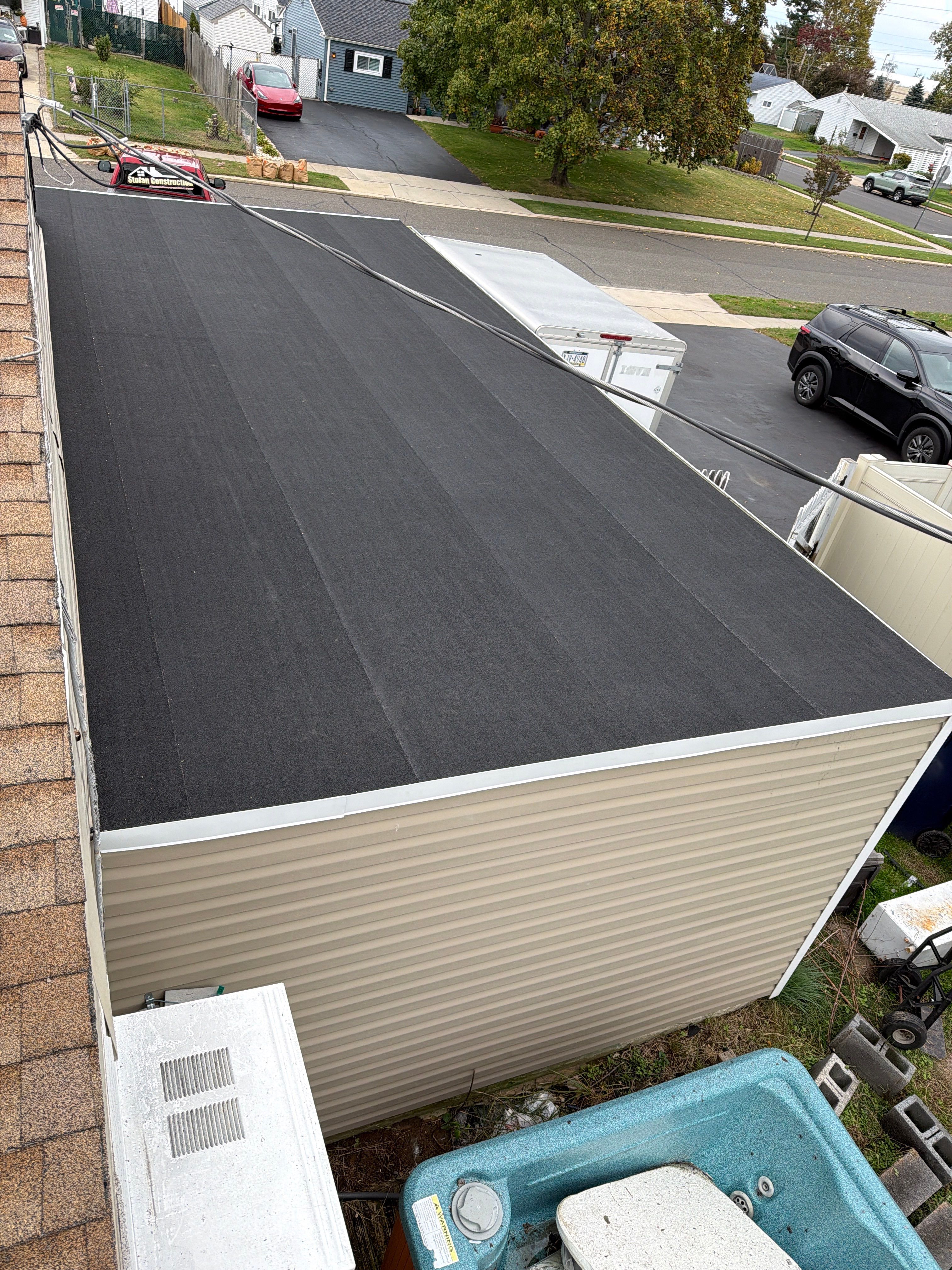 Flat Roof Replacement and Shingle Integration in Levittown by Stofan Construction LLC