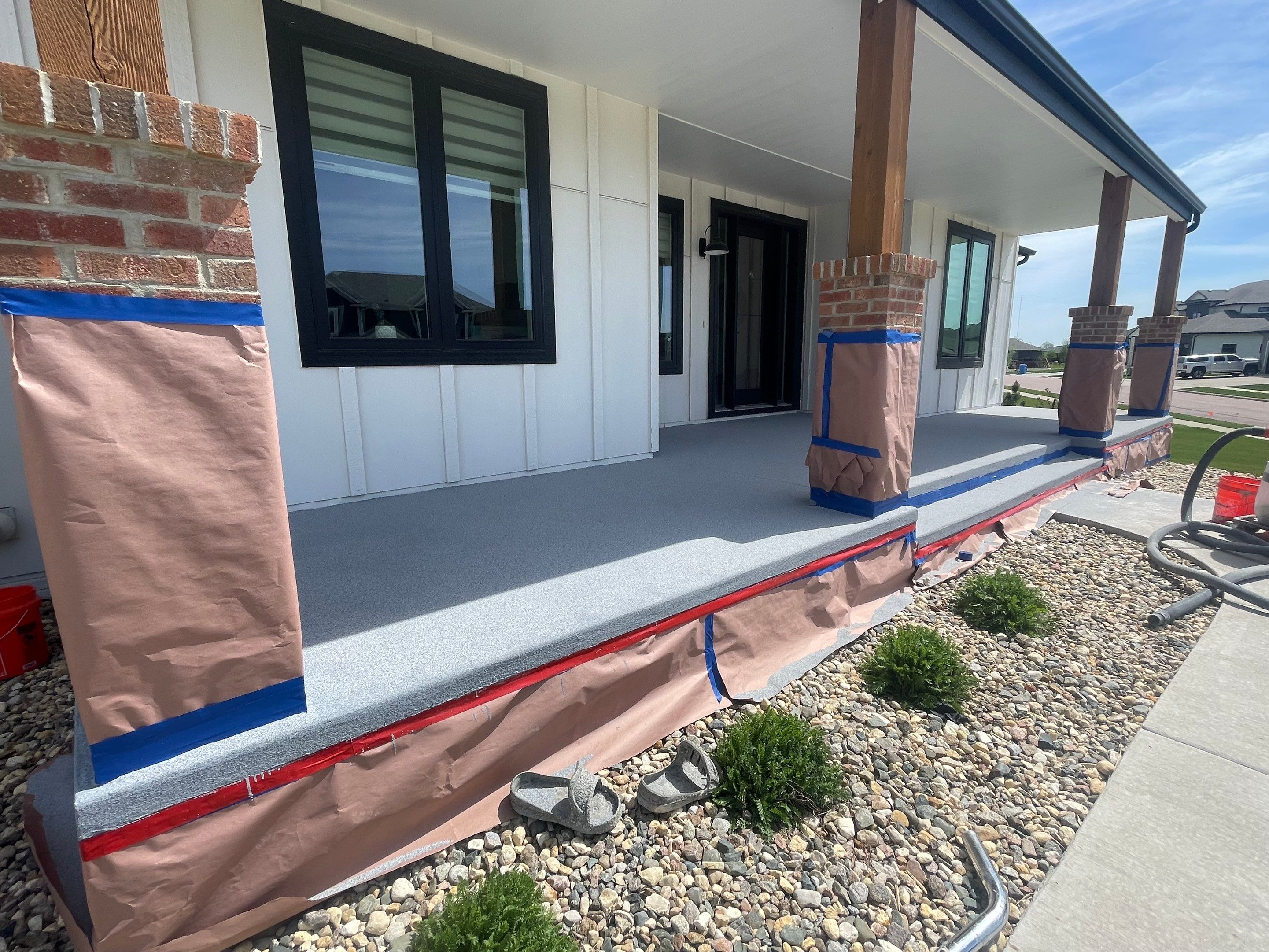 Grey Speckled Concrete Porch Coating for Sioux Falls Home by Select Painting, Coatings & Garage Cabinets