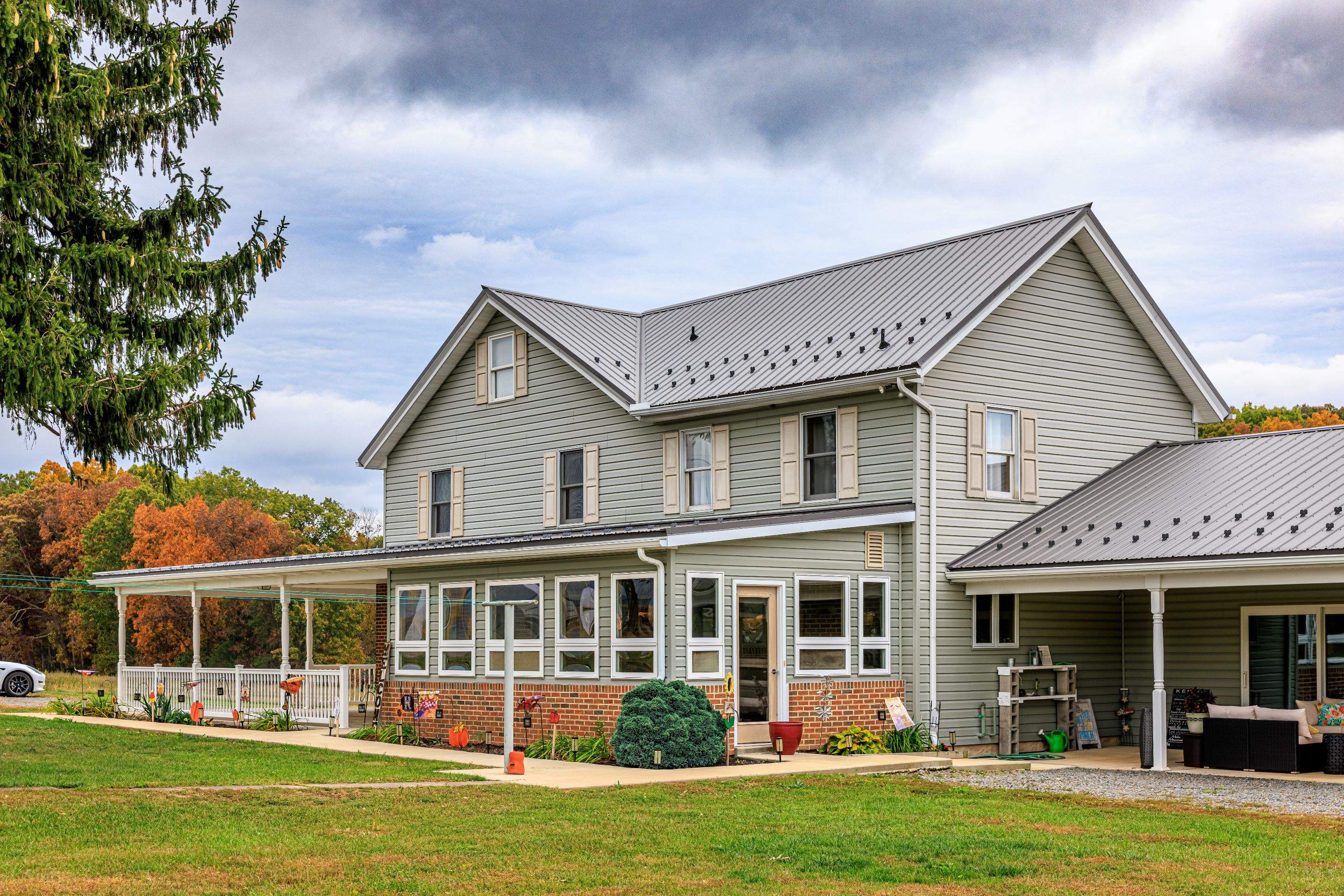 Classic Farmhouse With Textured Charcoal Metal Roof by Esh Builders