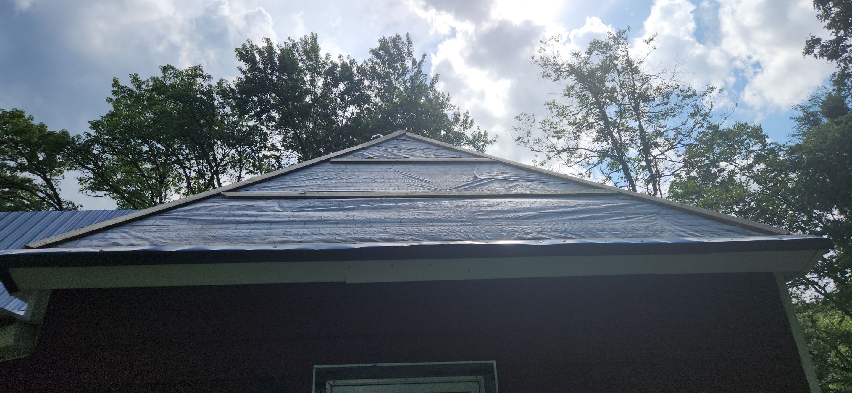 Residential Roofing Installation using 26 Gauge Colored Panels by Hostetler Roofing
