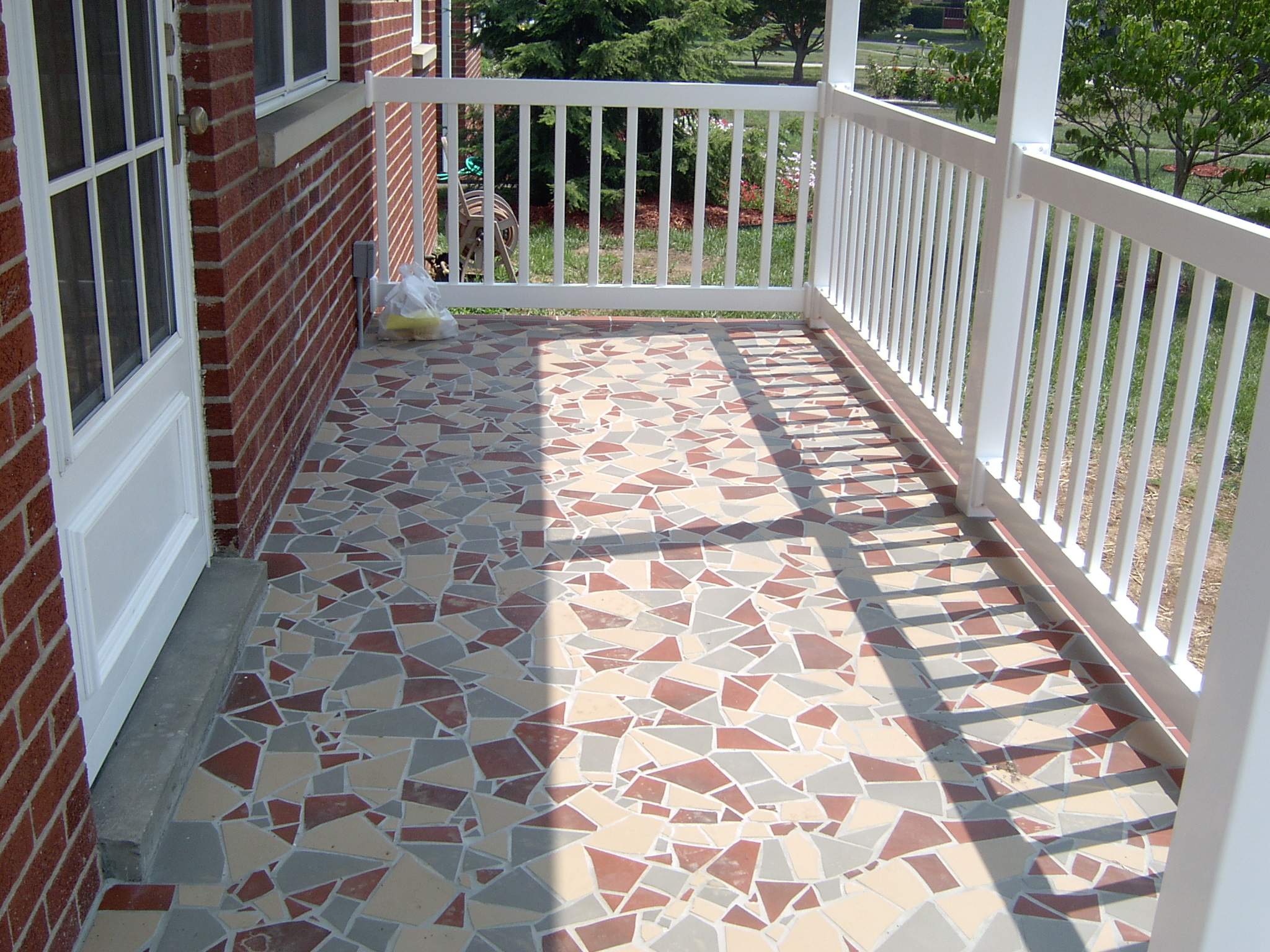 New front porch build, with tile floor and vinyl railing. by Secure Construction Company Inc
