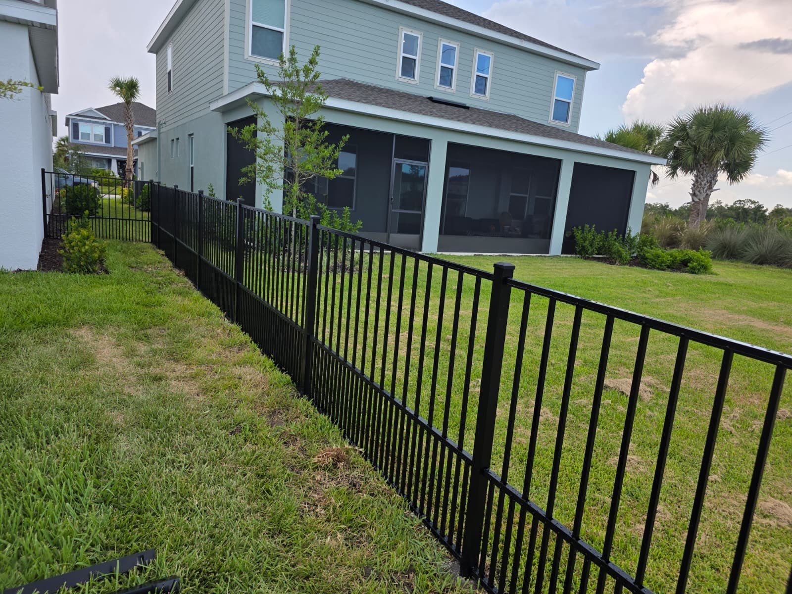 Black Aluminum Puppy Picket Fence Installation in Nokomis by True Fence LLC