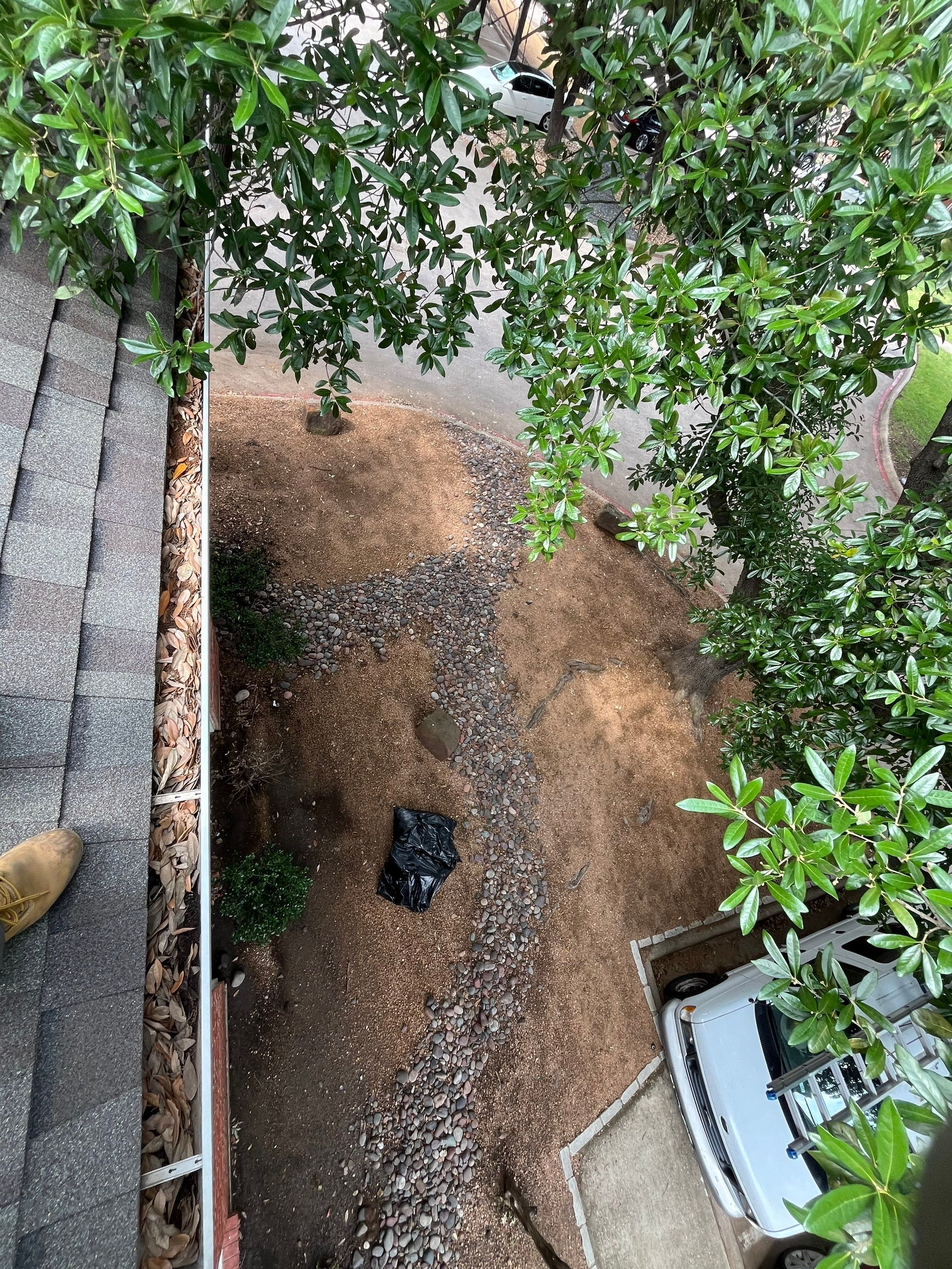 HOA gutter cleaning in Allen, TX,before  photo showing full gutters.